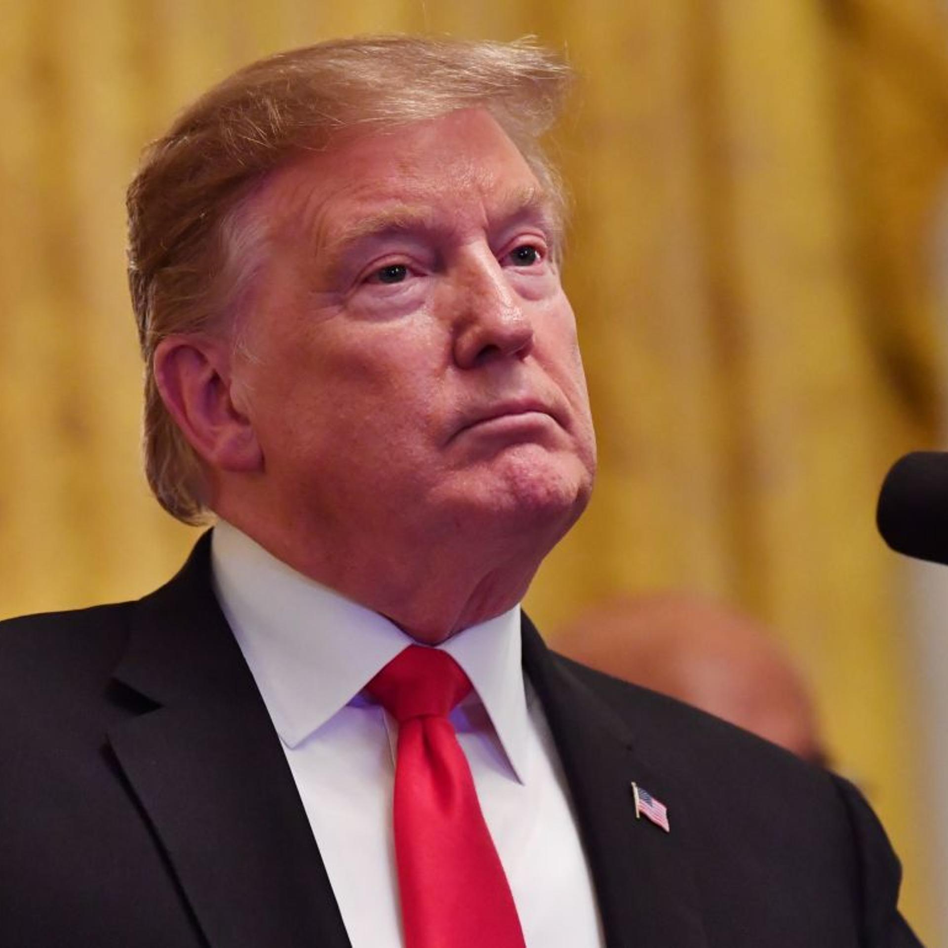 US President Donald Trump listens during a White House reception in honor of National African American History Month