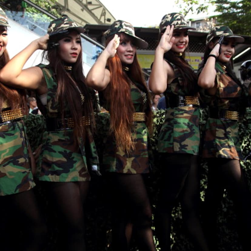 Presenters in soldier dress pose for photographs during "