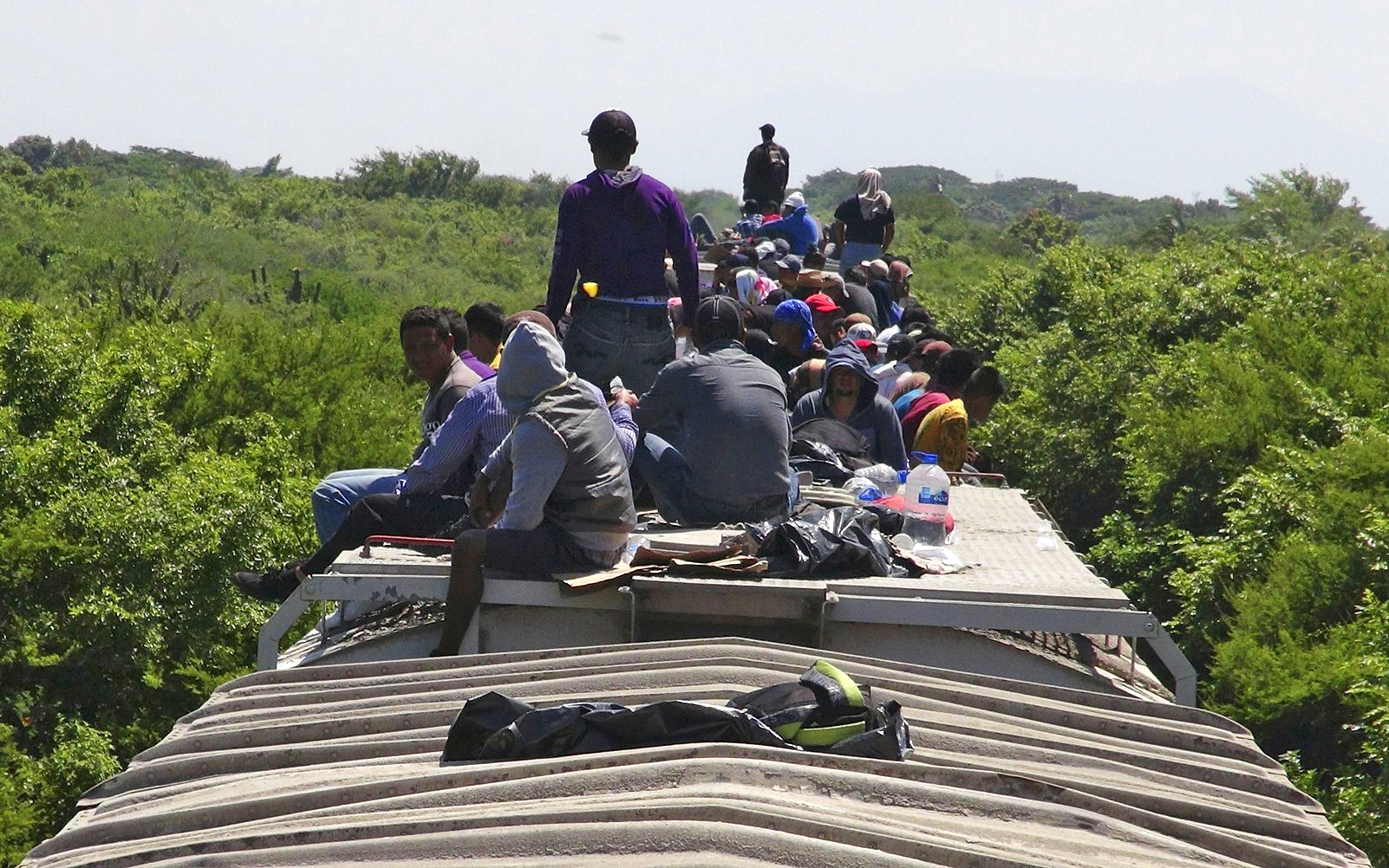 Unaccompanied minors ride atop the wagon of a freight train, known as La Bestia (The Beast) in Ixtepec, in the Mexican state of Oaxaca on June 18, 2014.
