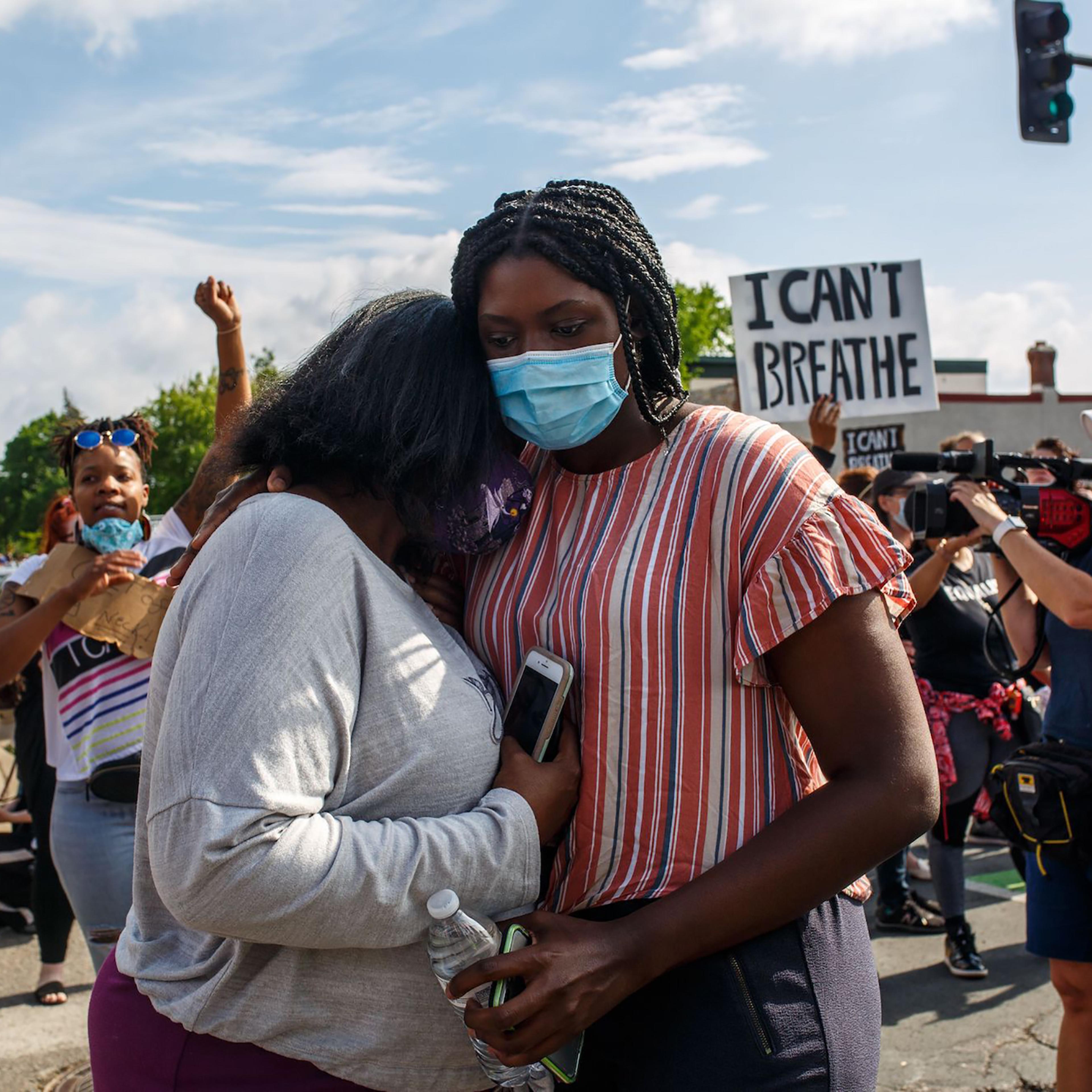 Two women embrace at a protest over the killing of George Floyd in Minneapolis on May 26, 2020.