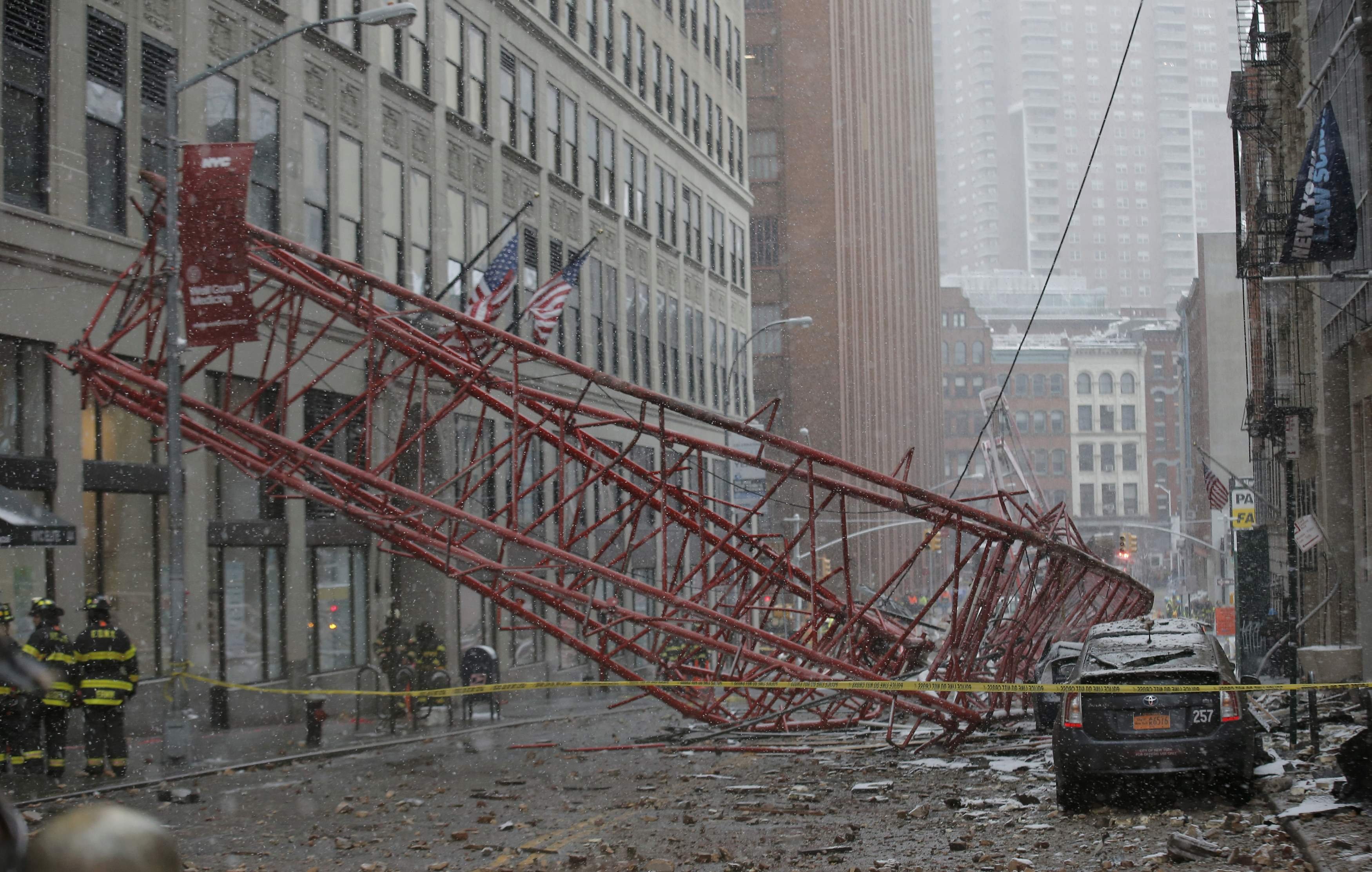 Emergency crews survey a massive construction crane collapse on a street in downtown Manhattan in New York