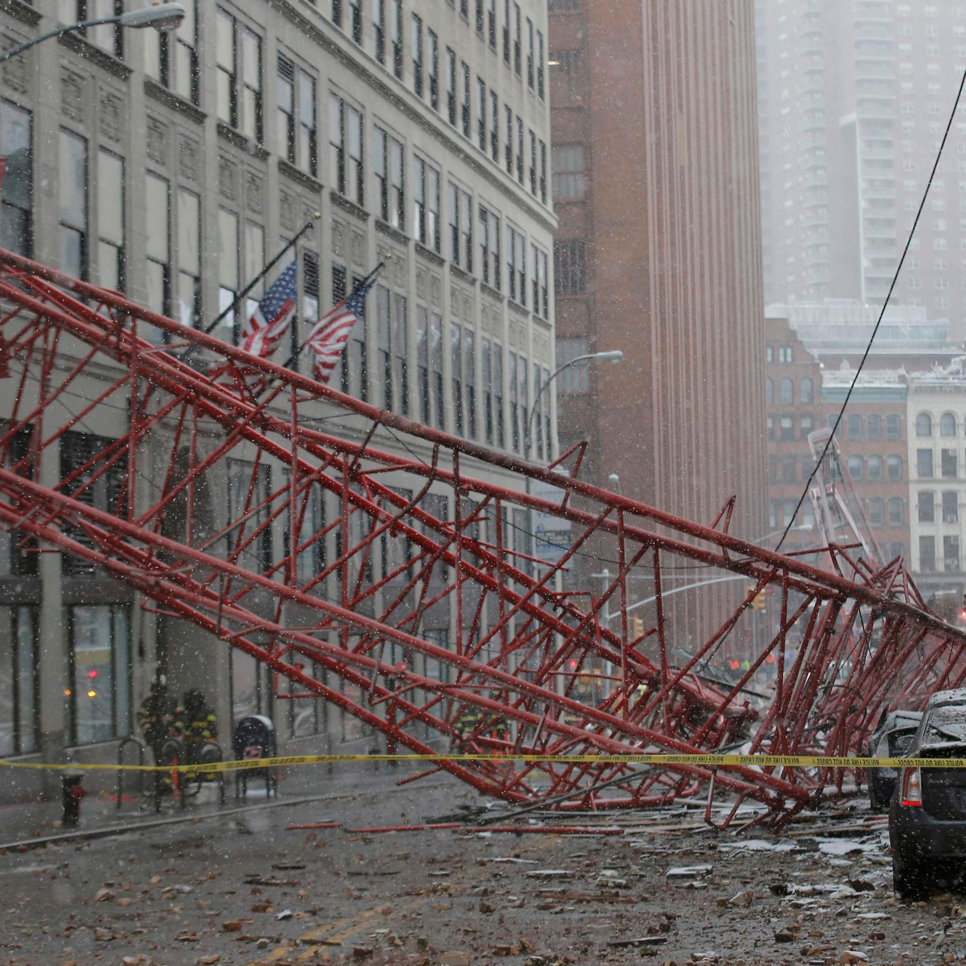 Emergency crews survey a massive construction crane collapse on a street in downtown Manhattan in New York