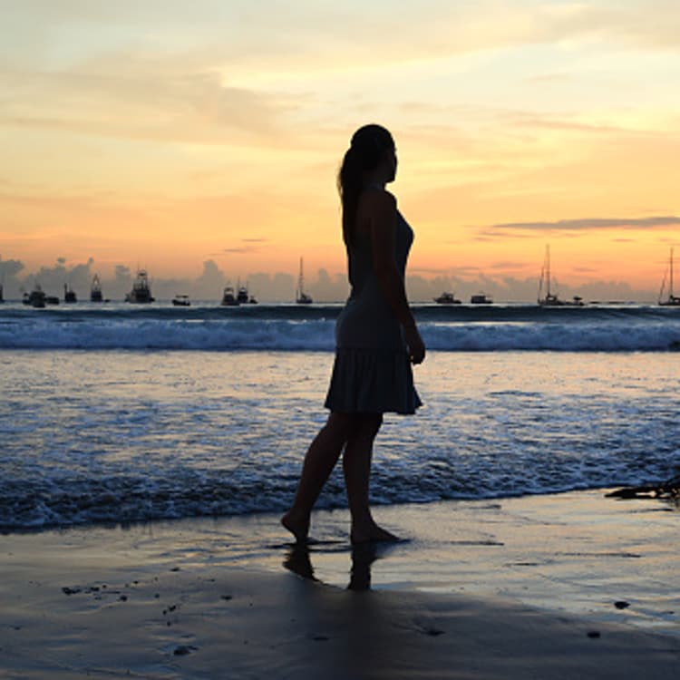 woman-standing-beach-silhouette