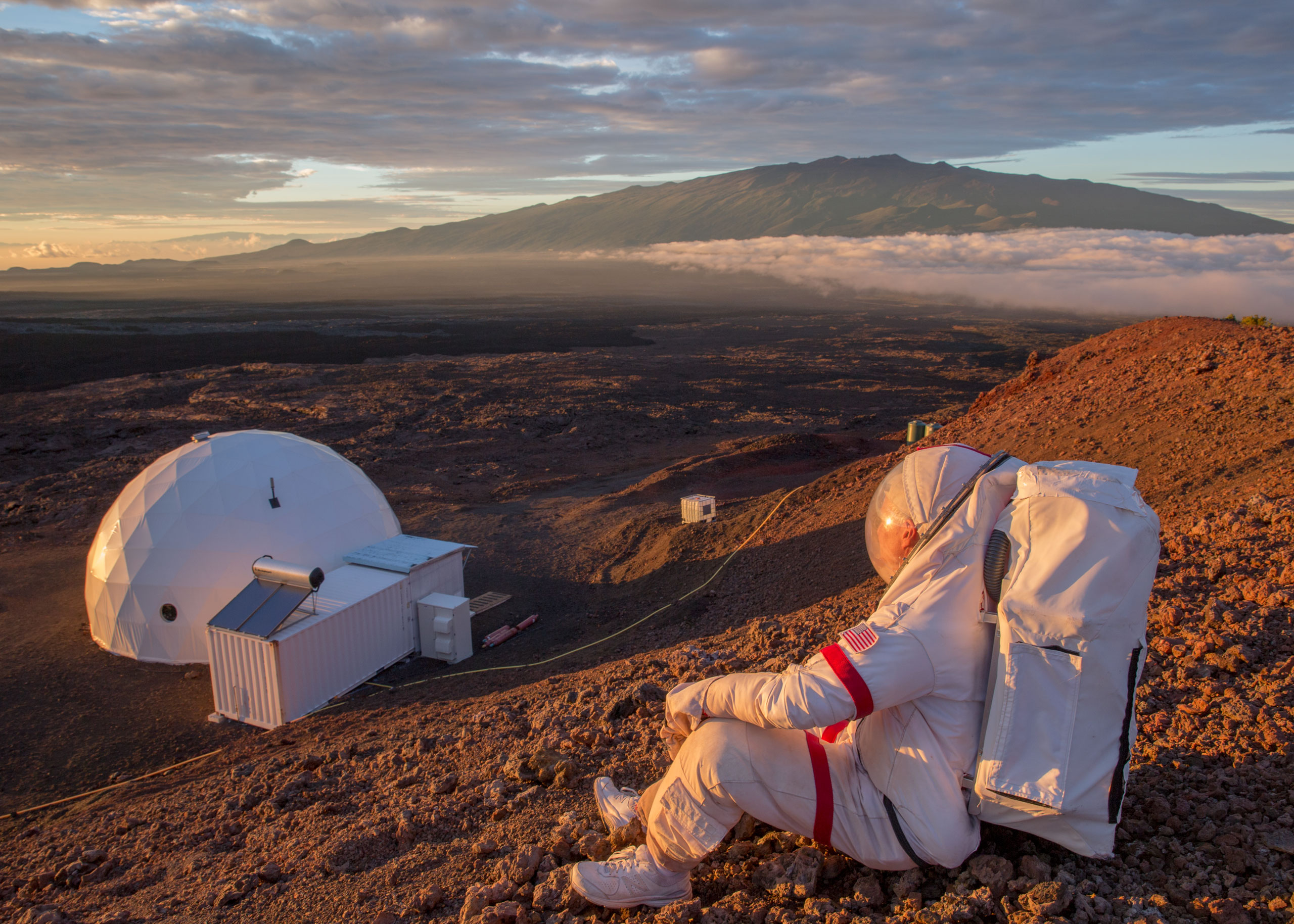 Kluger, suited up just as an astronaut would be, looks down at the HI-SEAS facility on Hawaii's Mauna Lao