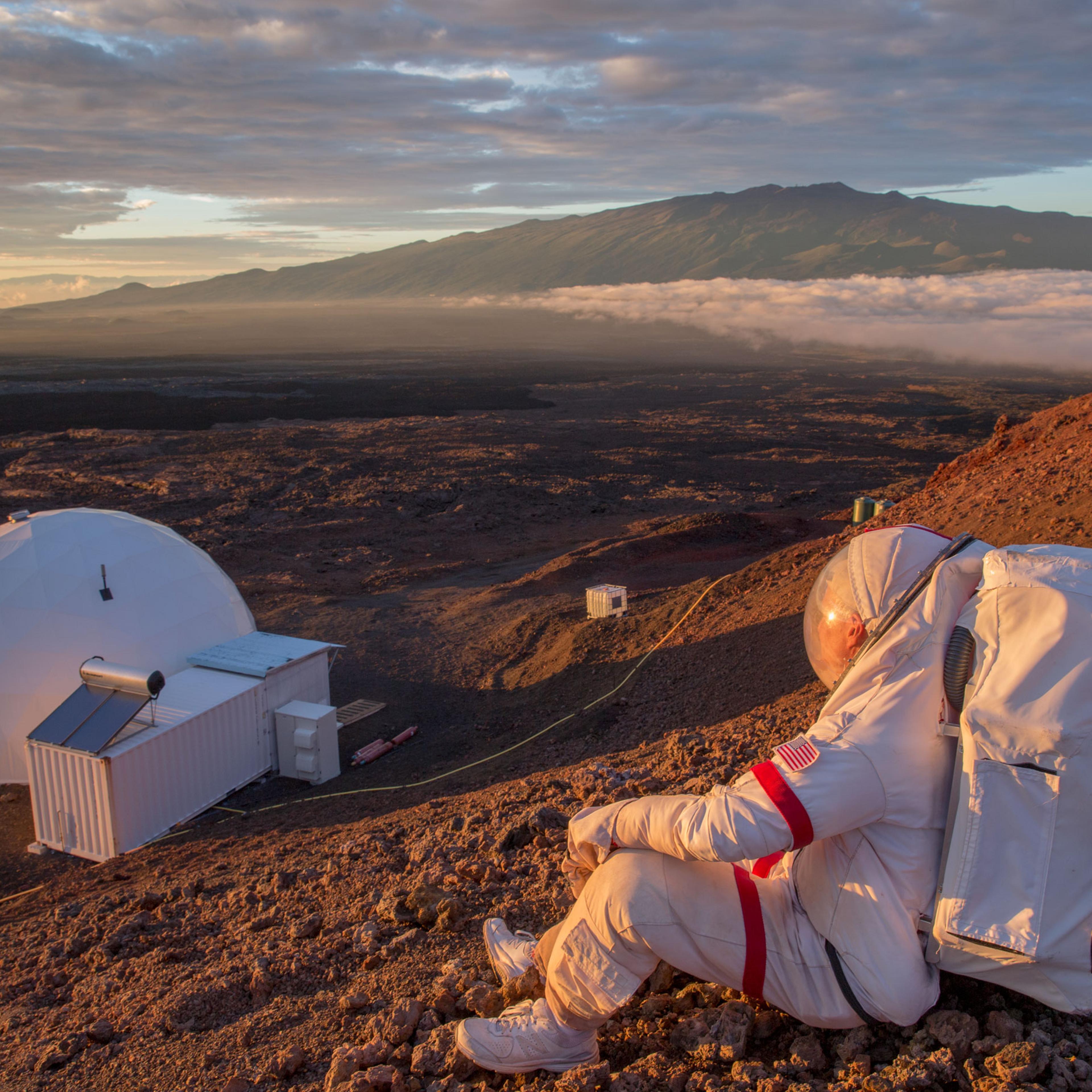 Kluger, suited up just as an astronaut would be, looks down at the HI-SEAS facility on Hawaii's Mauna Lao