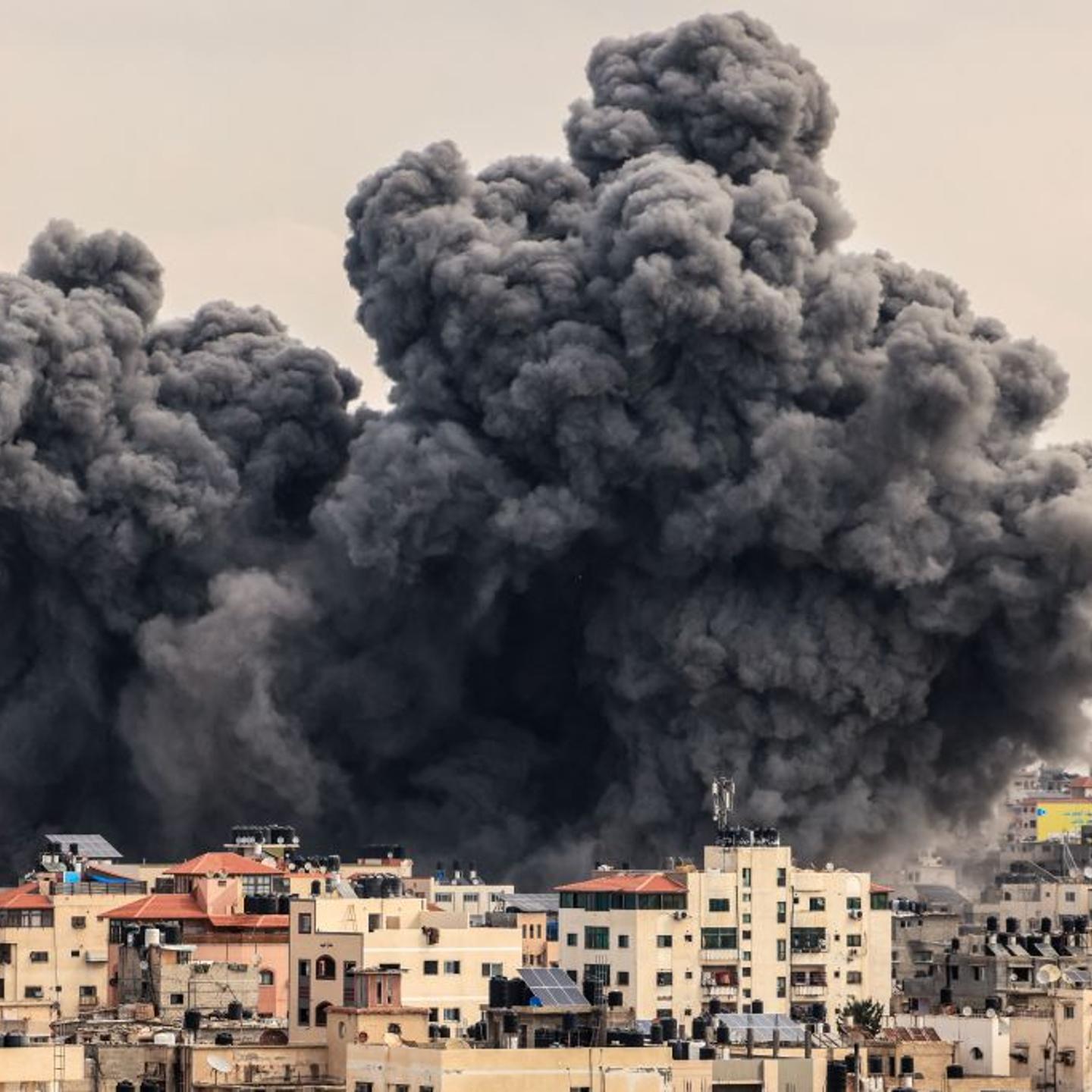 A plume of smoke rises in the sky of Gaza City during an Israeli airstrike on Oct. 9, 2023.
