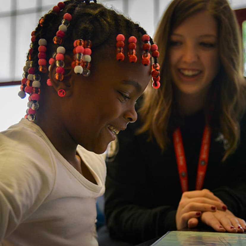 Americorps reading tutor Kelly Meany, L, gives one-on-one reading instructions to 7-year-old 2nd grader Madissen Moody at C.W. Harris Elementary School on Friday, September 19, 2014, in Washington, DC.