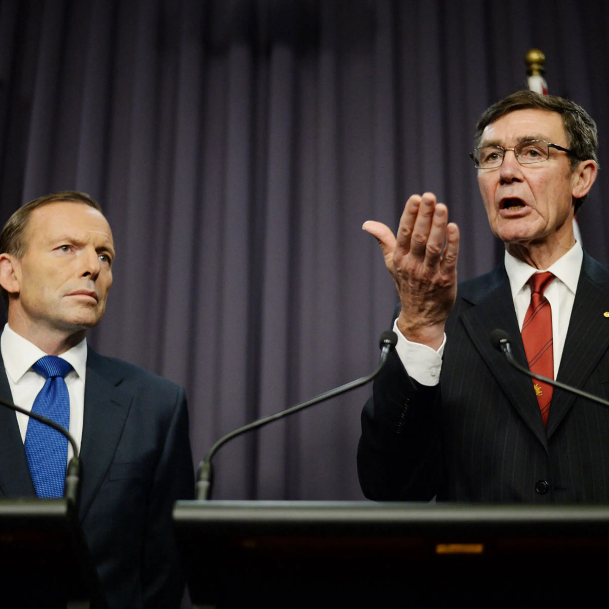 From left: Prime Minister Tony Abbott listens as Angus Houston, in charge of joint search efforts, speaks to the media during a press conference at Parliament House in Canberra on April 28, 2014.