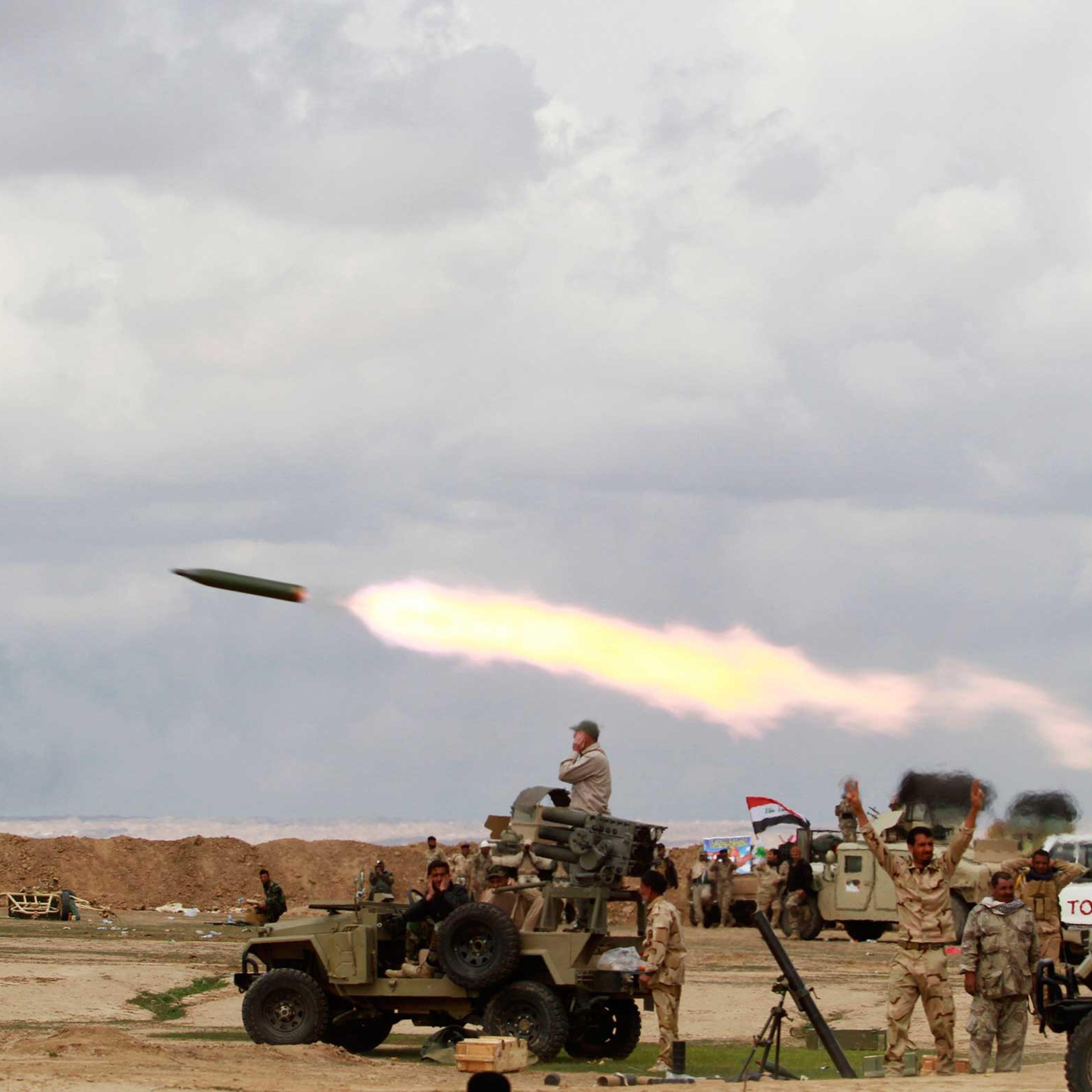 Shi’ite fighters launch a rocket towards ISIS militants during heavy fighting in Salahuddin province, Iraq, March 4, 2015.