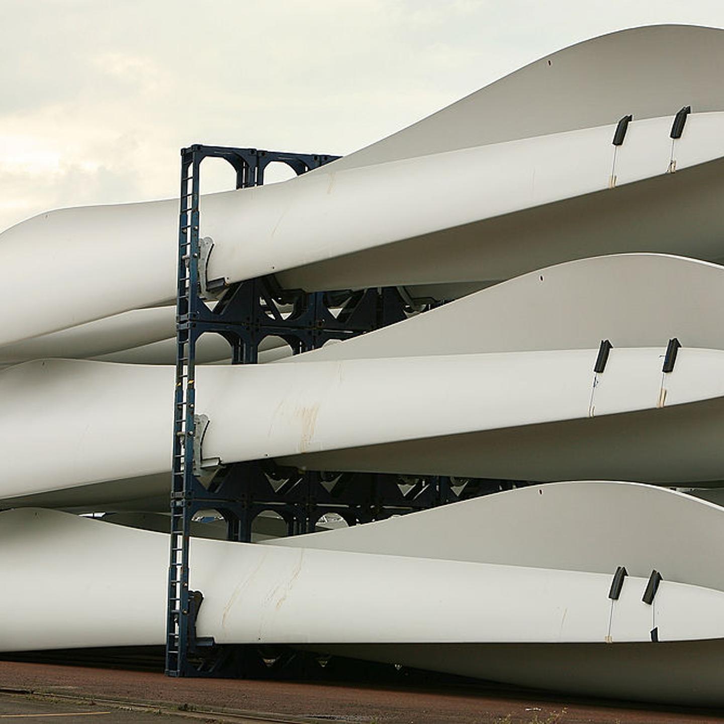 A worker passes stored wind turbine blades at the Harland & Wolff shipyard on Aug. 14, 2008 in Belfast, Northern Ireland.