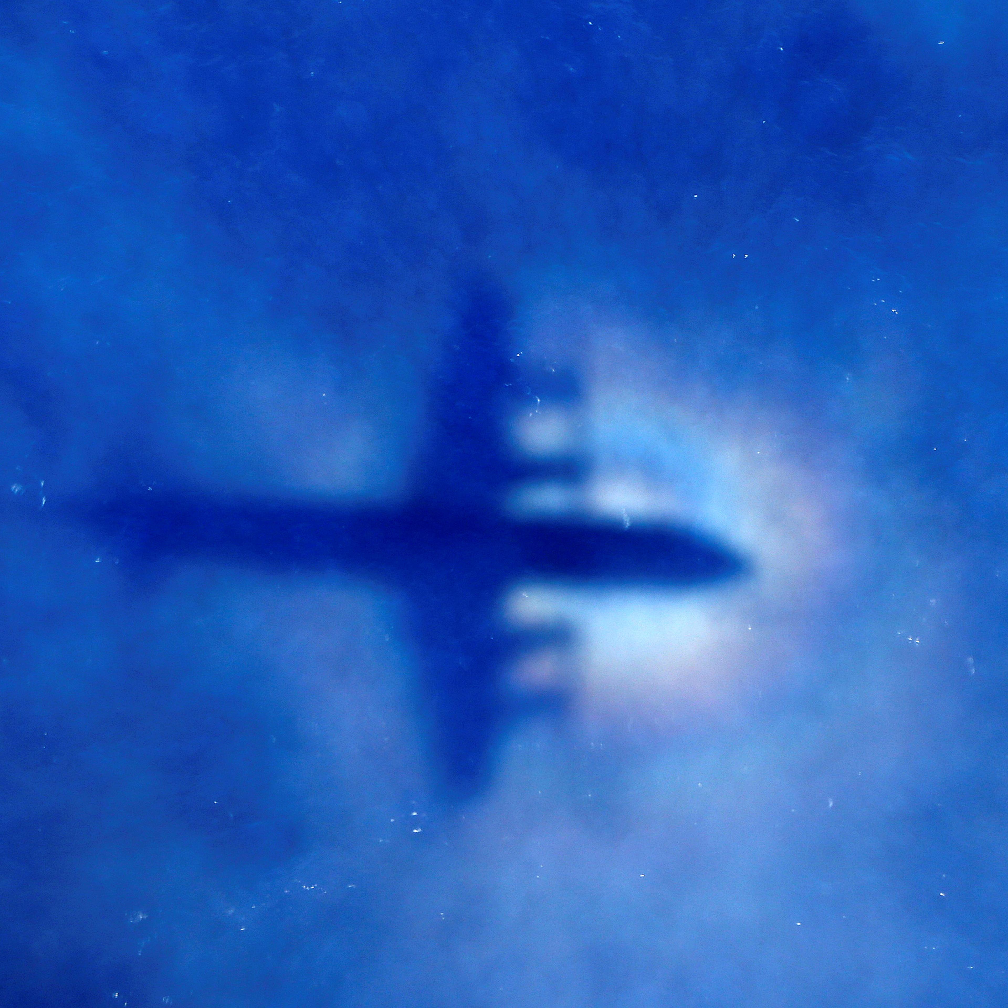 The shadow of a Royal New Zealand Air Force (RNZAF) P3 Orion maritime search aircraft can be seen on low-level clouds as it flies over the southern Indian Ocean looking for missing Malaysian Airlines flight MH370