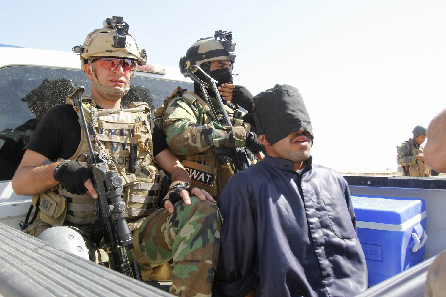 Personnel from the Kurdish security forces detain a man suspected of being a militant belonging to the al Qaeda-linked Islamic State in Iraq and Syria (ISIS) in the outskirts of Kirkuk June 16.