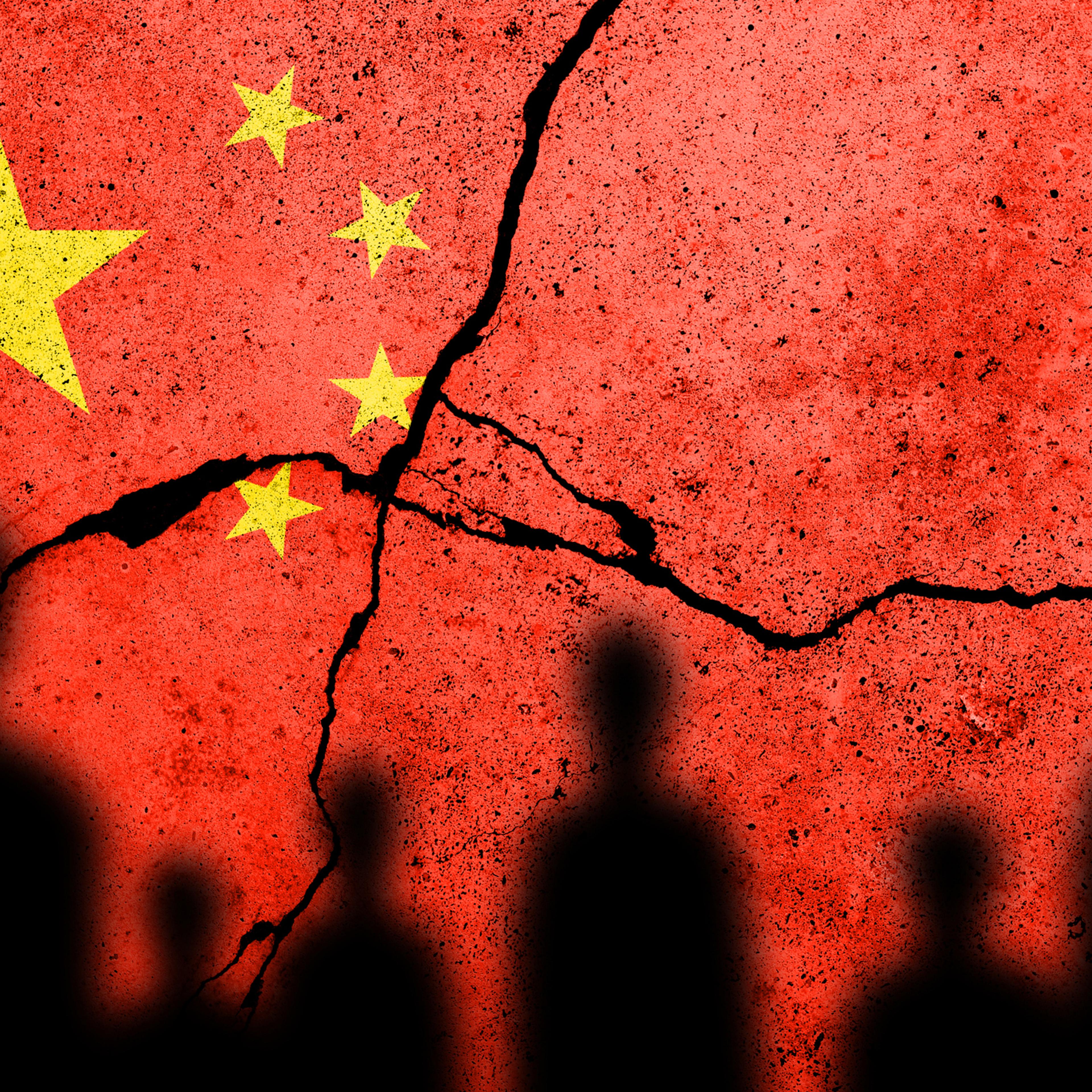 Flag of China painted on a cracked wall. Chinese real estate and debt crisis