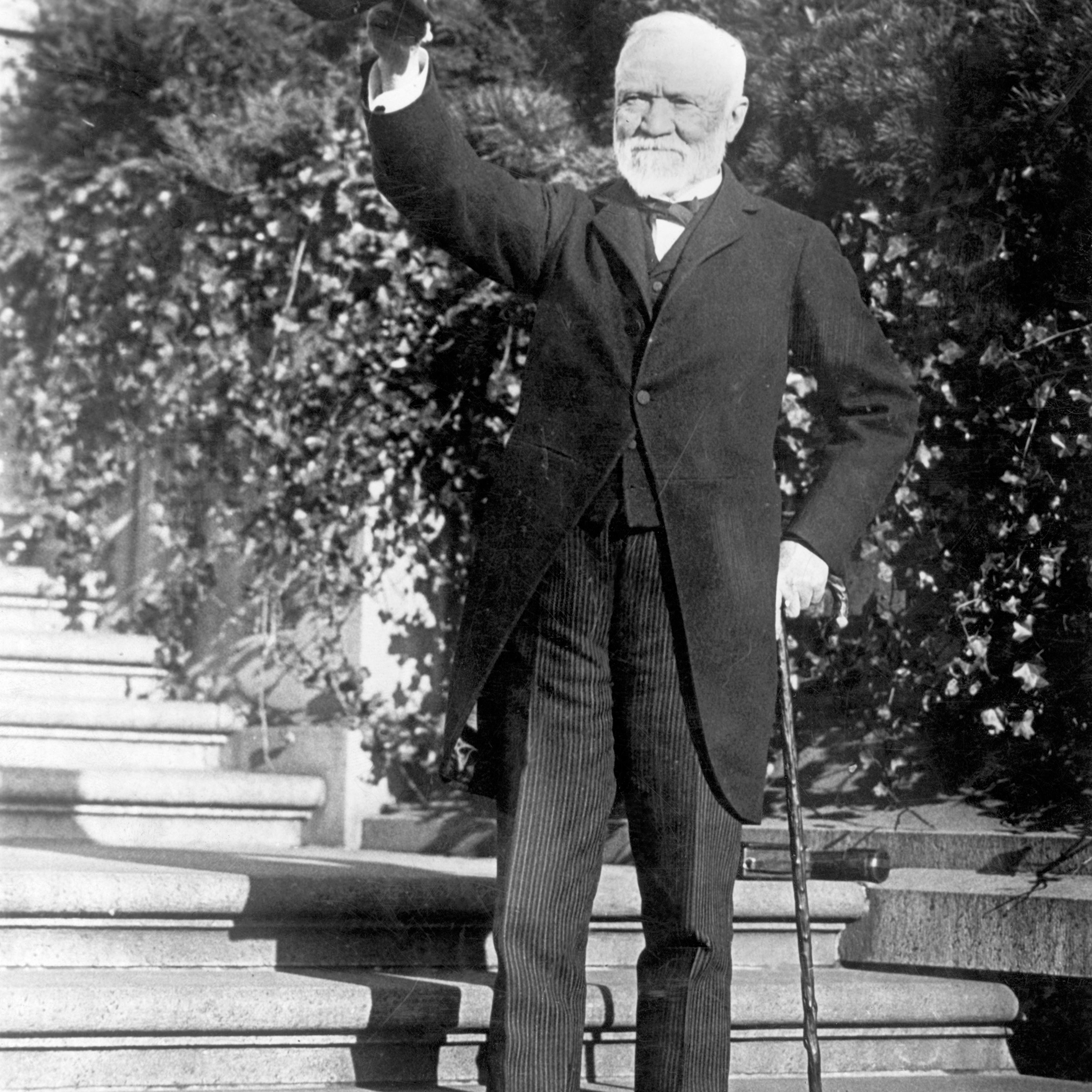 Andrew Carnegie standing on the steps of his estate, circa 1910s.