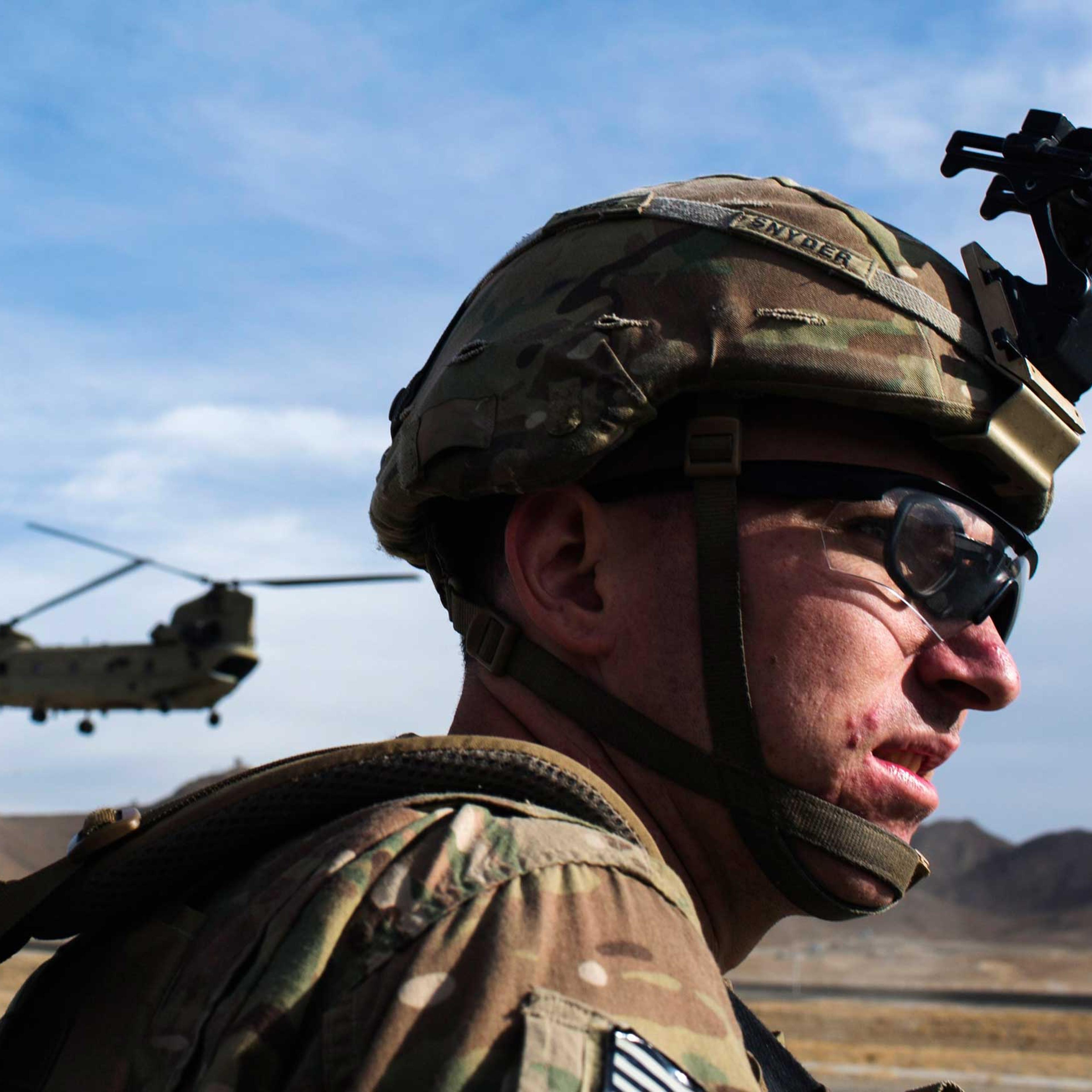 A U.S. soldier waits for a CH-47 Chinook helicopter from the 82nd Combat Aviation Brigade to land after an advising mission at the Afghan National Army headquarters for the 203rd Corps in the Paktia province of Afghanistan