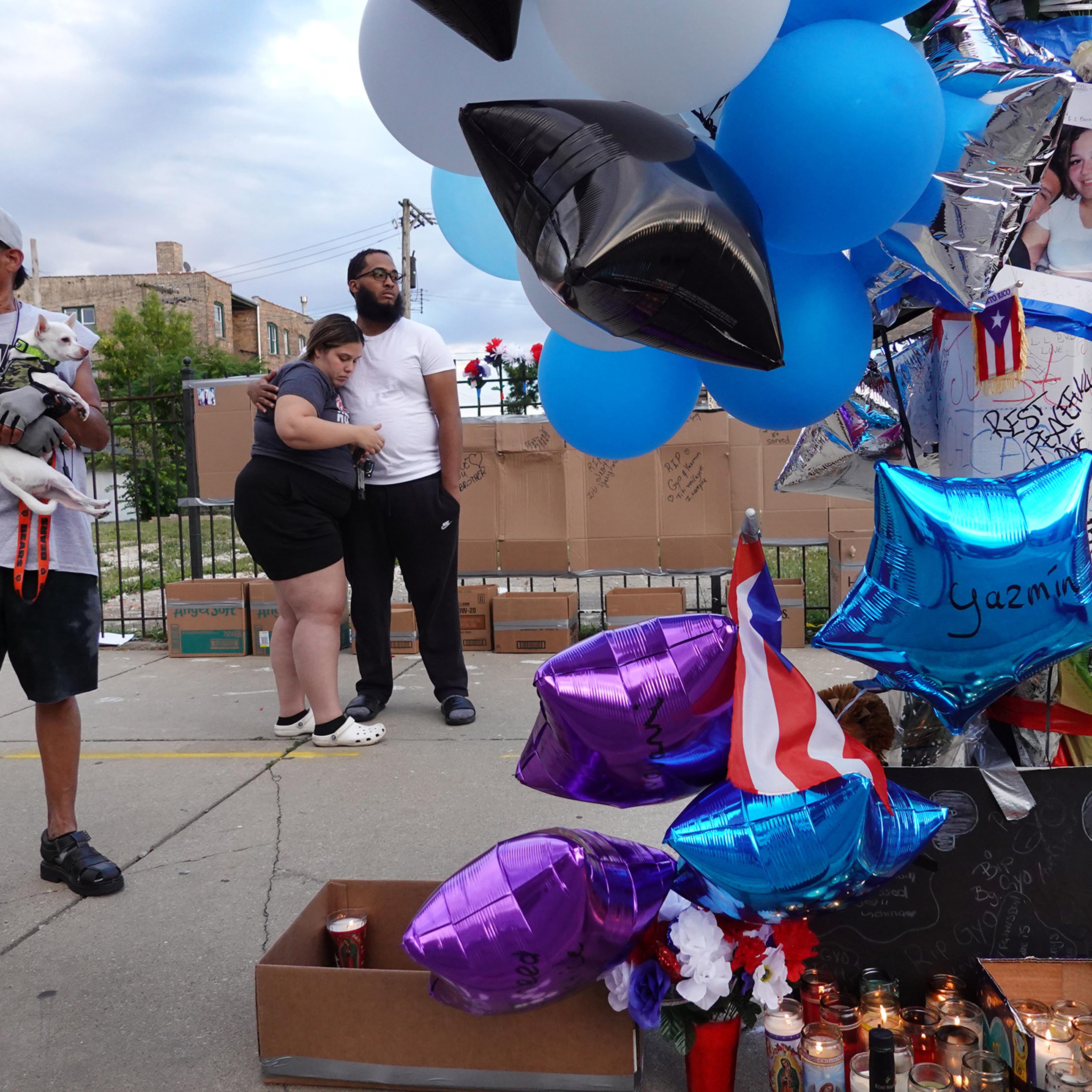 Mourners gather to remember Gyovanni Arzuaga, 24, and Yasmin Perez, 25, at a makeshift memorial at the location where both were shot as they celebrated their Puerto Rican heritage Saturday in the Humboldt Park neighborhood on June 22 in Chicago.