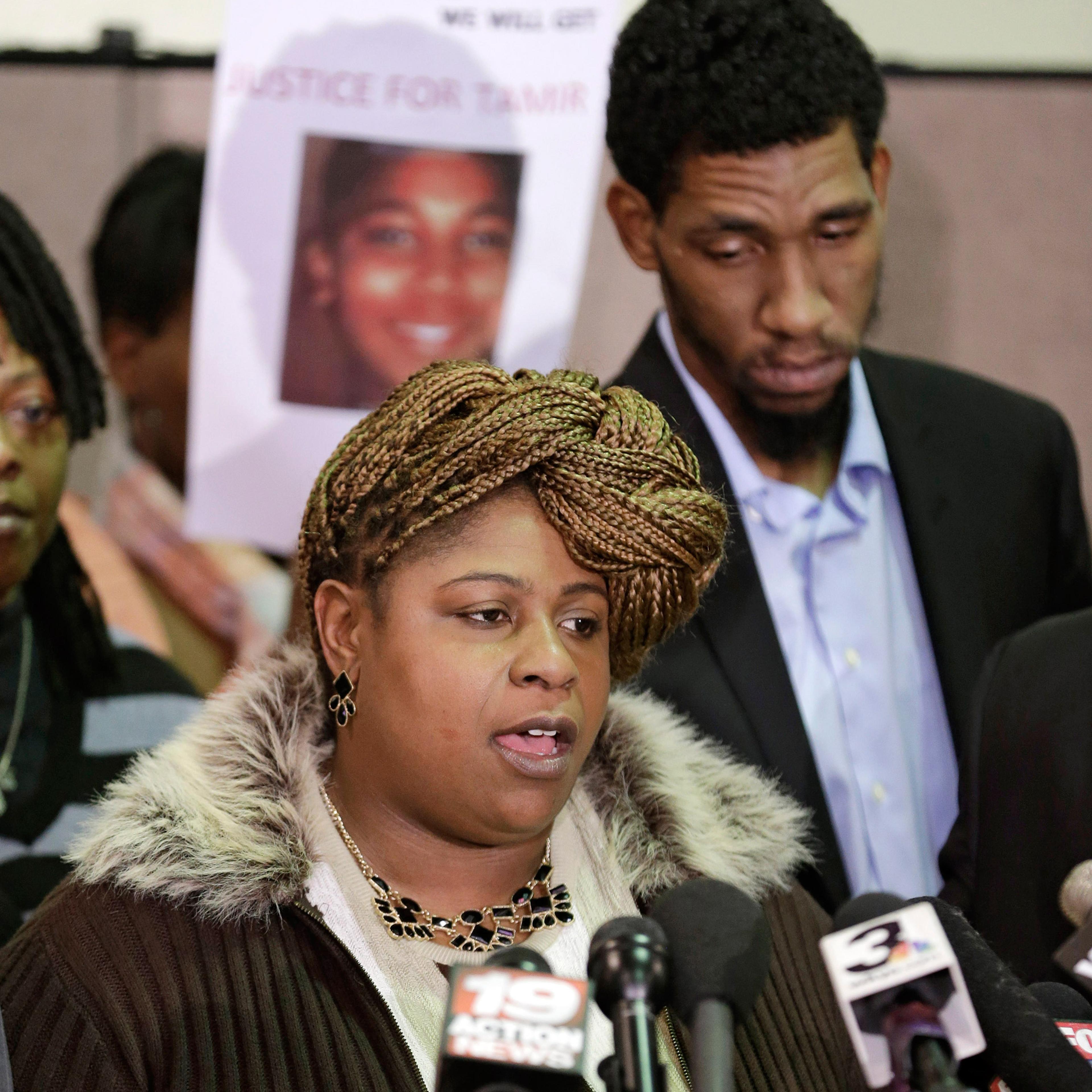 Samaria Rice, mother of Tamir, the 12-year-old boy who was fatally shot by a Cleveland police officer, speaks as Leonard Warner, Tamir's father, listens during a news conference in Cleveland, Ohio, Dec. 8, 2014.