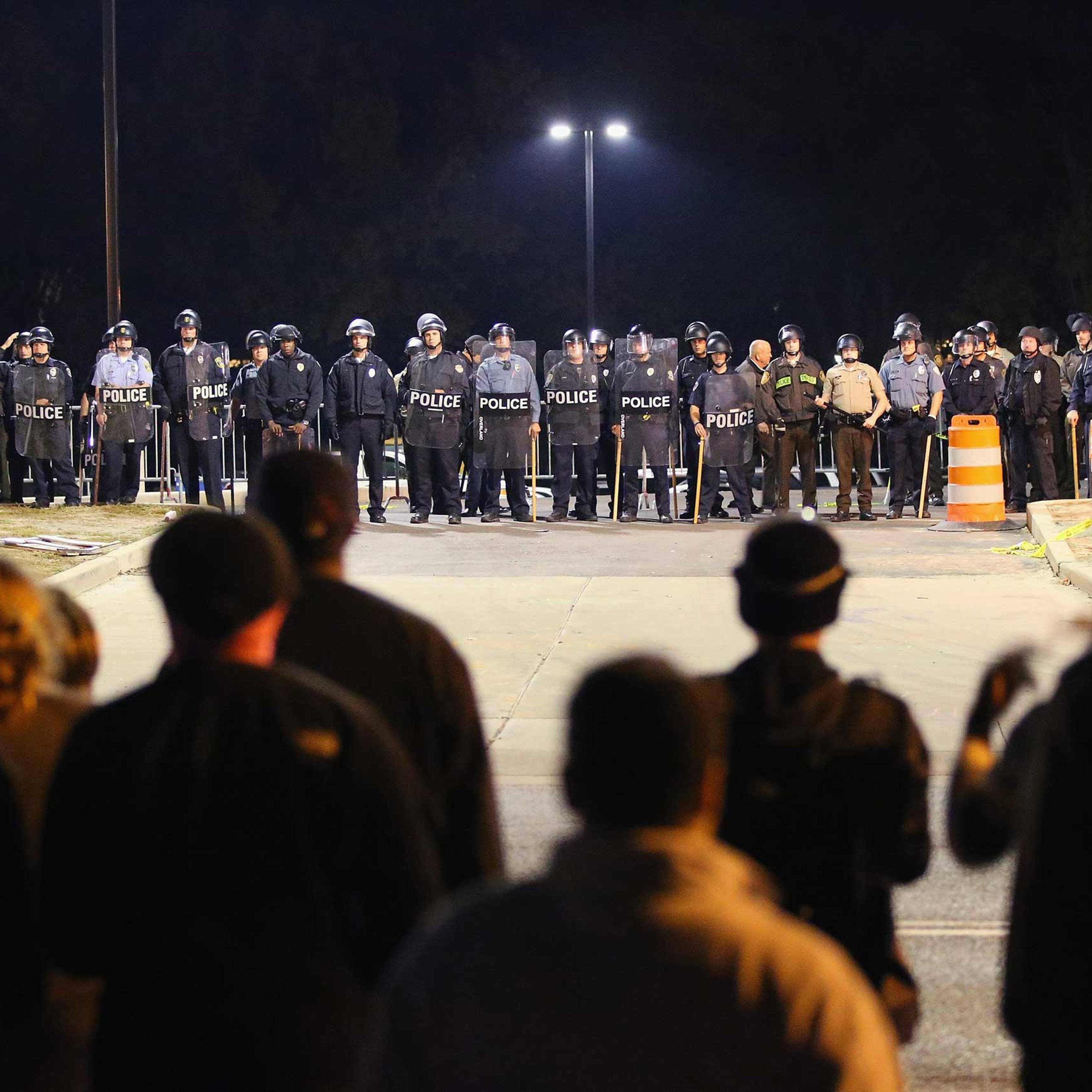 Police face off with demonstrators outside the police station as protests continue in the wake of 18-year-old Michael Brown's death on Oct. 22, 2014 in Ferguson, Missouri.
