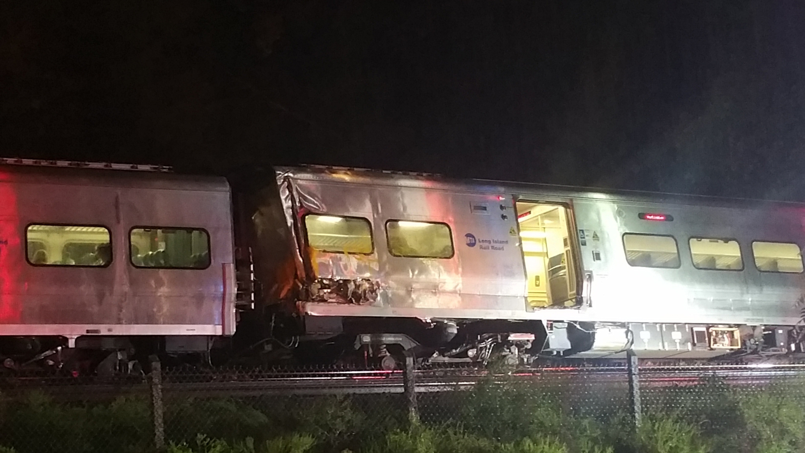 In this photo provided by Sarah Qamar shows a Long Island Railroad train derailed near New Hyde Park, N.Y., Saturday, Oct. 8, 2016. The commuter train derailed east of New York City after it hit a work train on the tracks. A spokesman for the Long Island