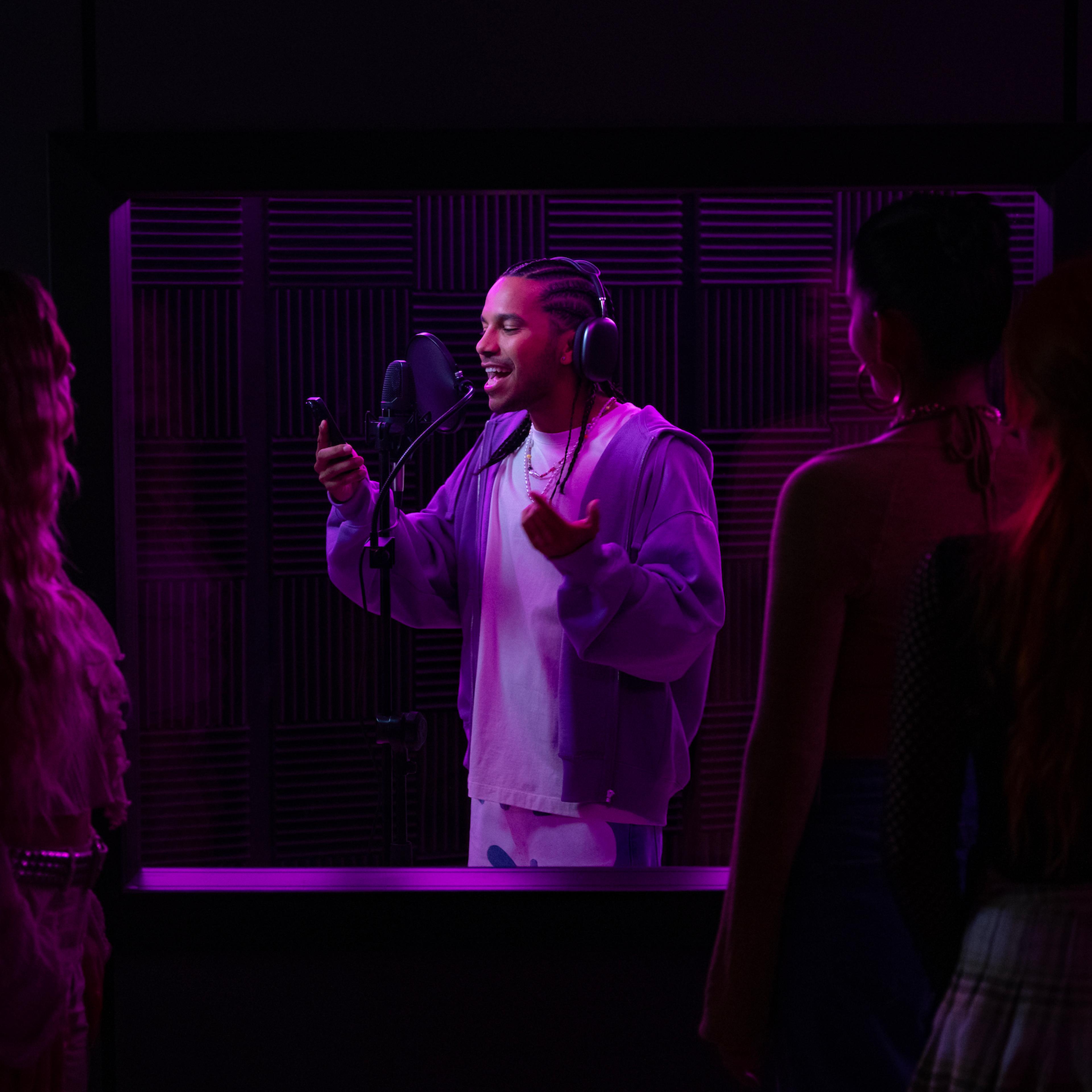 Up-and-coming reggaeton artist Santi (Tyler Dean Flores) records a track in the studio.