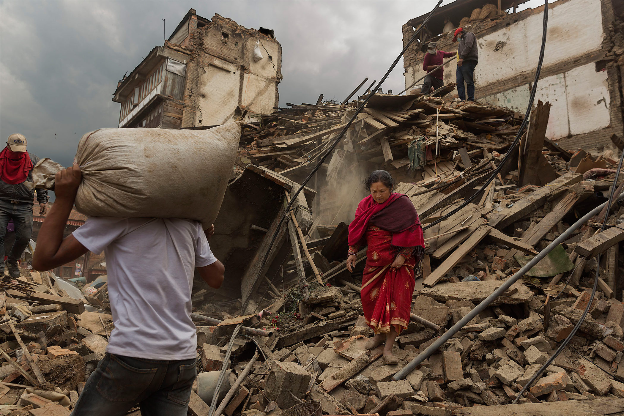 Nepal earthquake. Bhaktapur. A city near Katmandu. People reclaiming their possessions from the wreckage. A man who had been buried and died being pulled out of the wreckage by there Nepali Army rescue team. Sculpture of elephant in ruins of an ancient, 