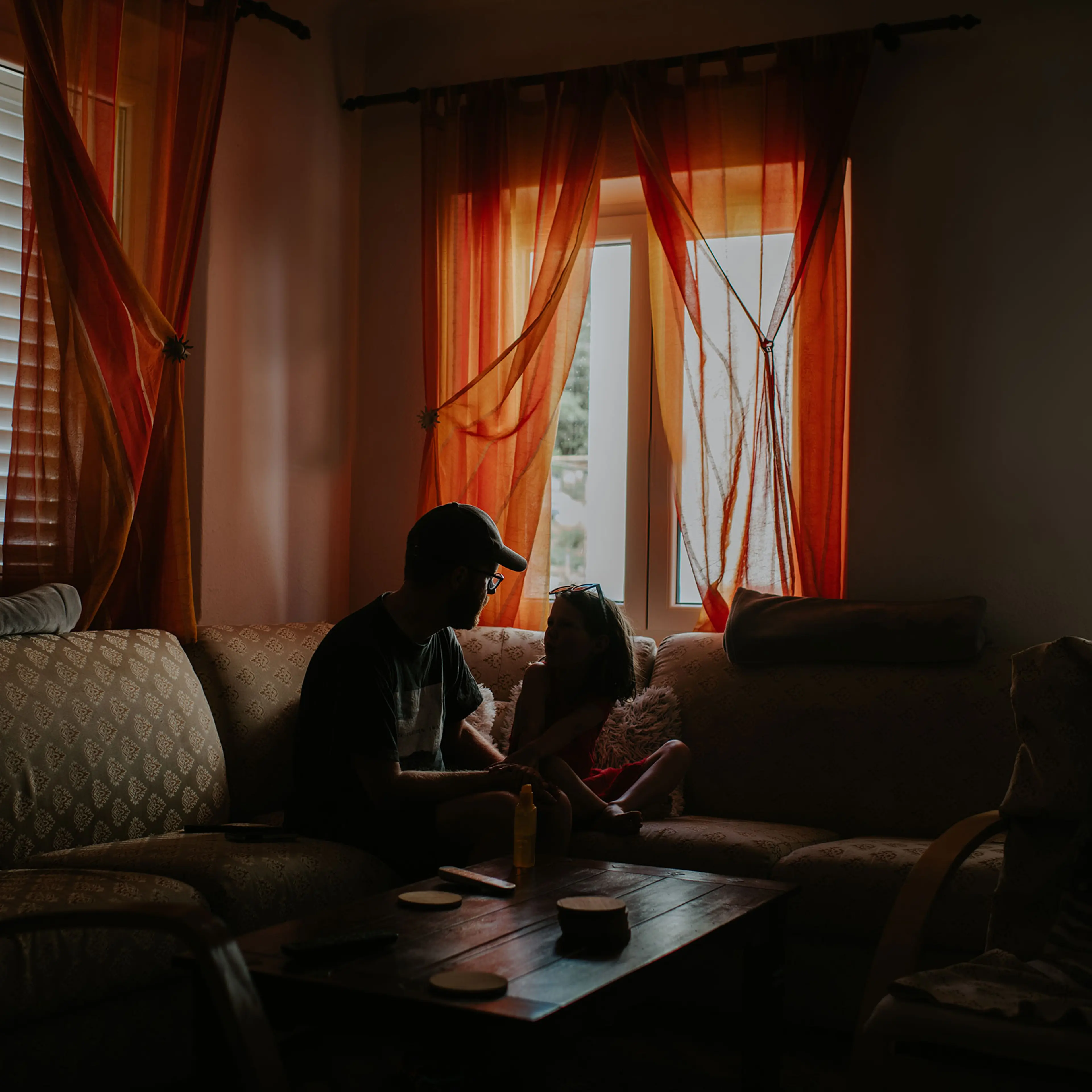 A father and daughter share a quiet moment in a home environment