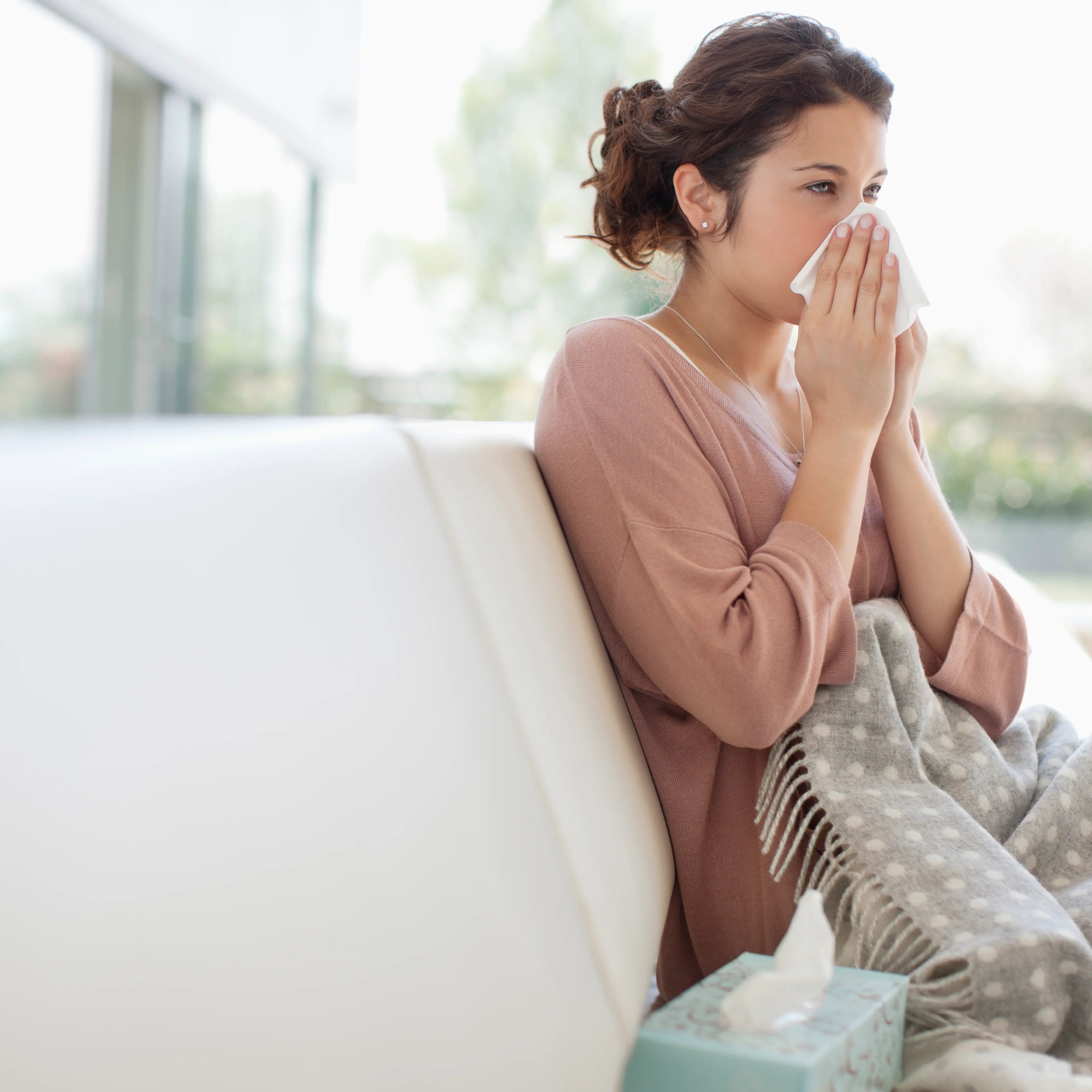 woman-sneezing-couch