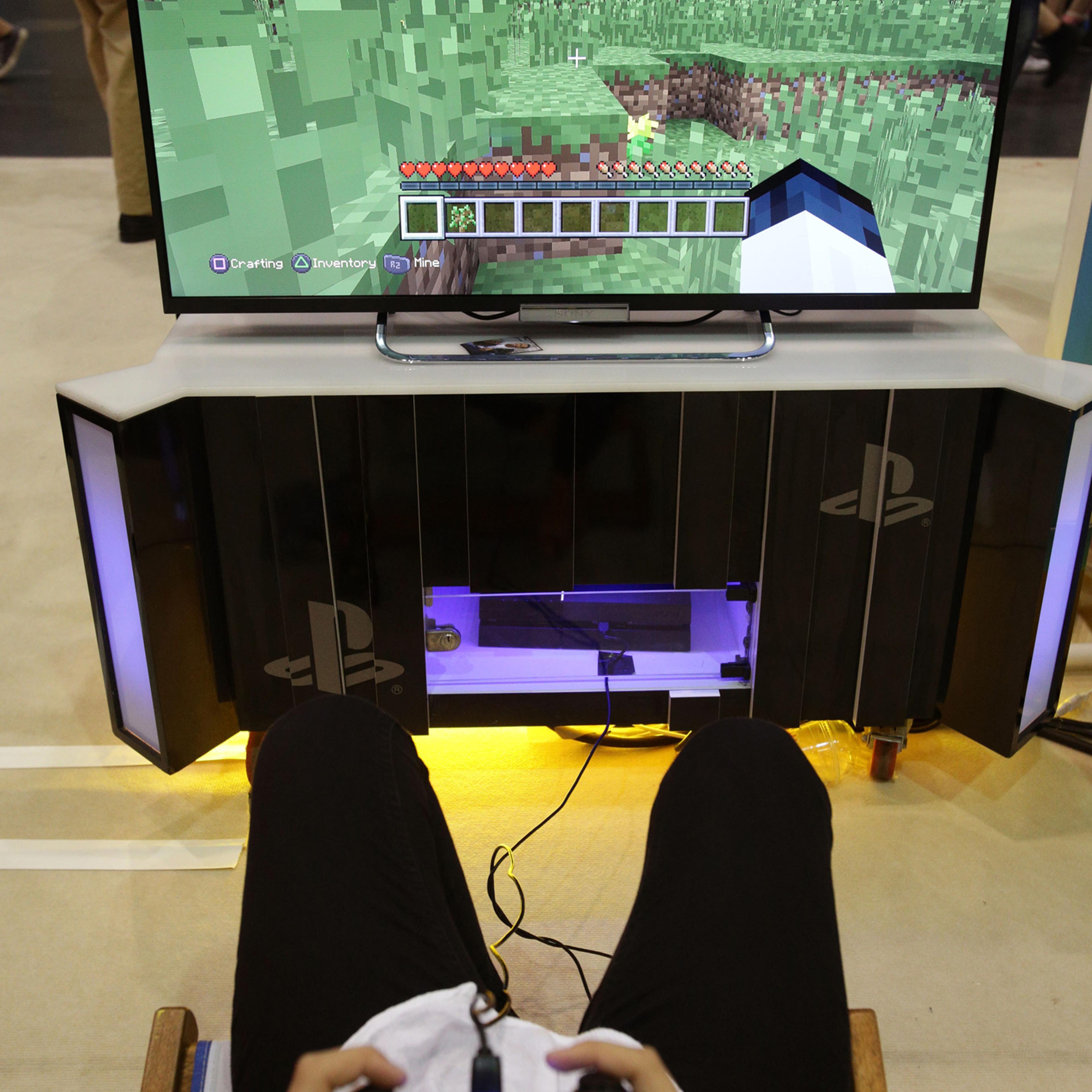 A visitor playing a game of Minecraft at the Summer in the City festival, the UK's largest YouTube community event at Alexandra Palace in London, Aug. 9, 2014.