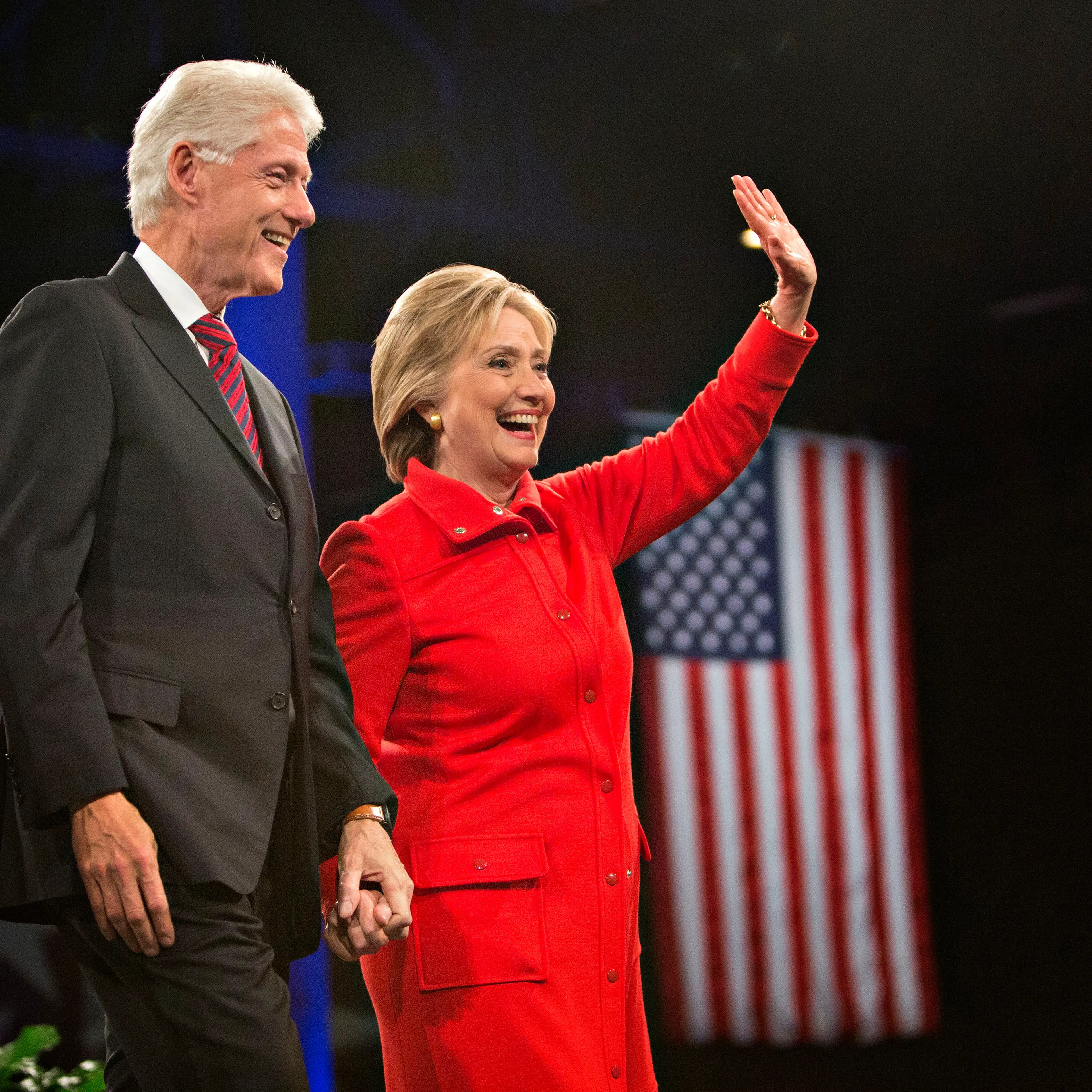 Hillary Clinton, former U.S. secretary of state and 2016 Democratic presidential candidate, right, stands on stage with husband Bill Clinton, former U.S. president, at the conclusion of the Jefferson-Jackson Dinner in Des Moines, Iowa, U.S., on Oct. 24,