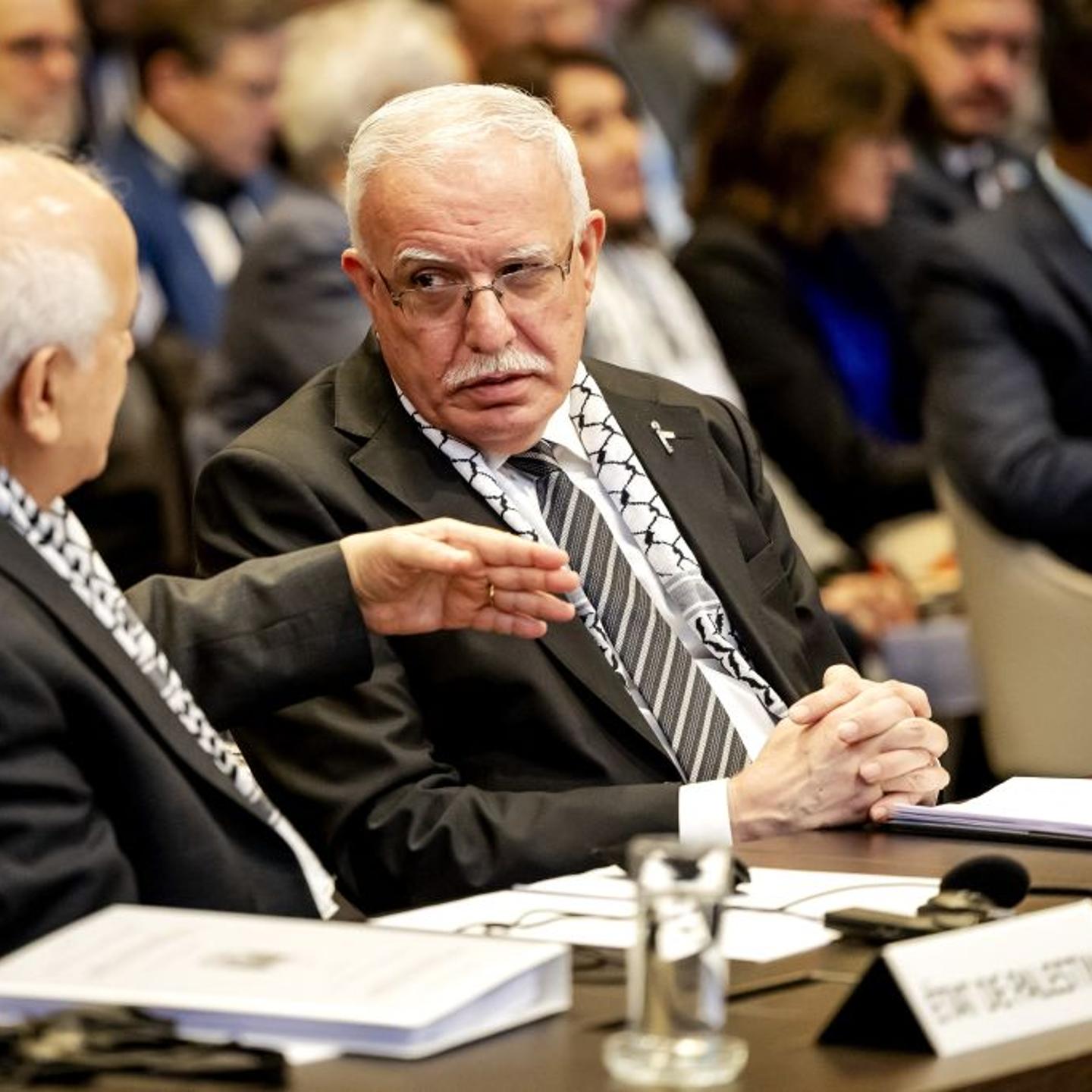 Minister of Foreign Affairs of the Palestinian Authority Riyad al-Maliki (R) listens to a colleague during a hearing at the International Court of Justice (ICJ) on the legal consequences of the Israeli occupation of Palestinian territories.