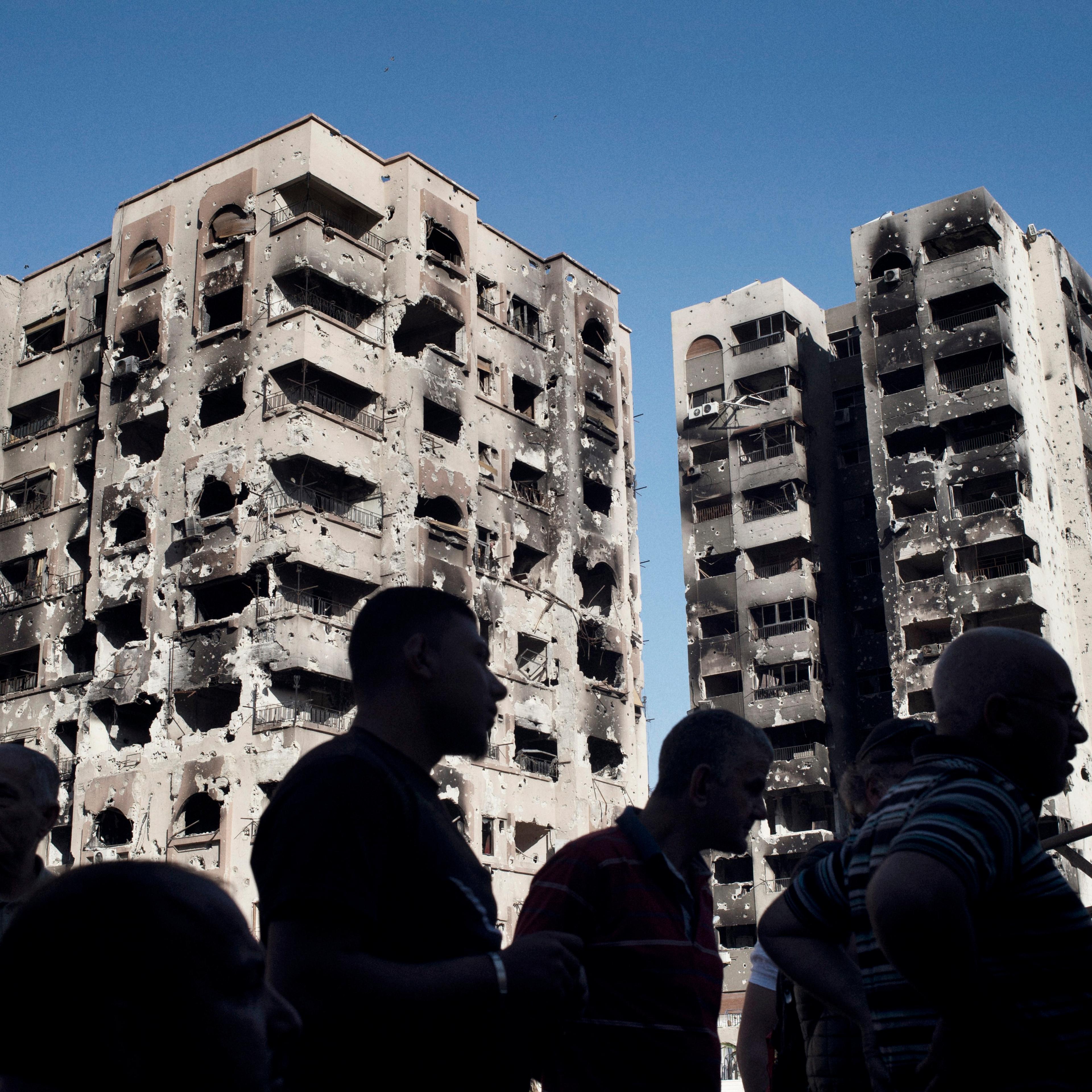 Men gather at a newly reopened mechanic's shop in the Barze neighborhood of Damascus on May 14, 2014.