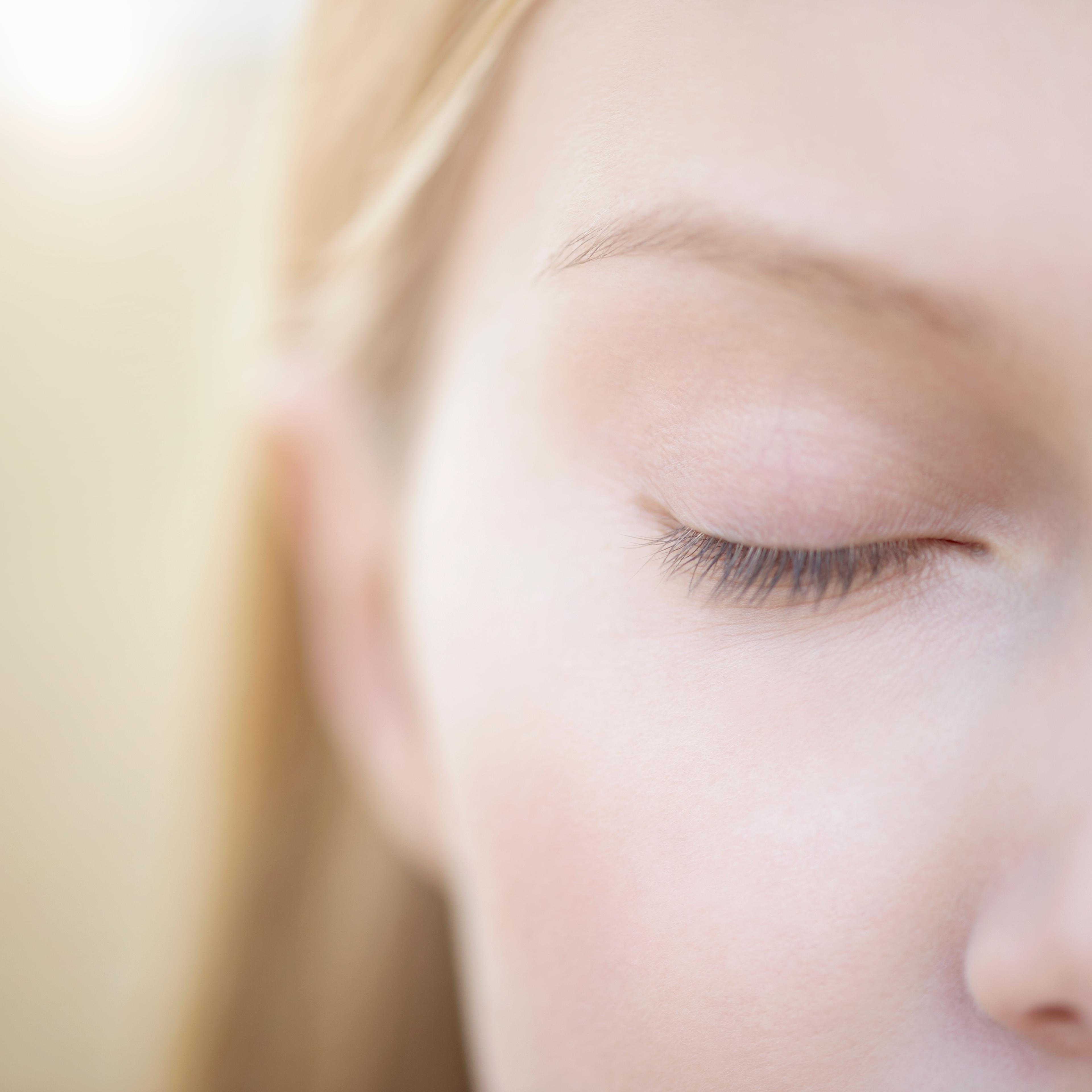 Close up of woman with eye closed.