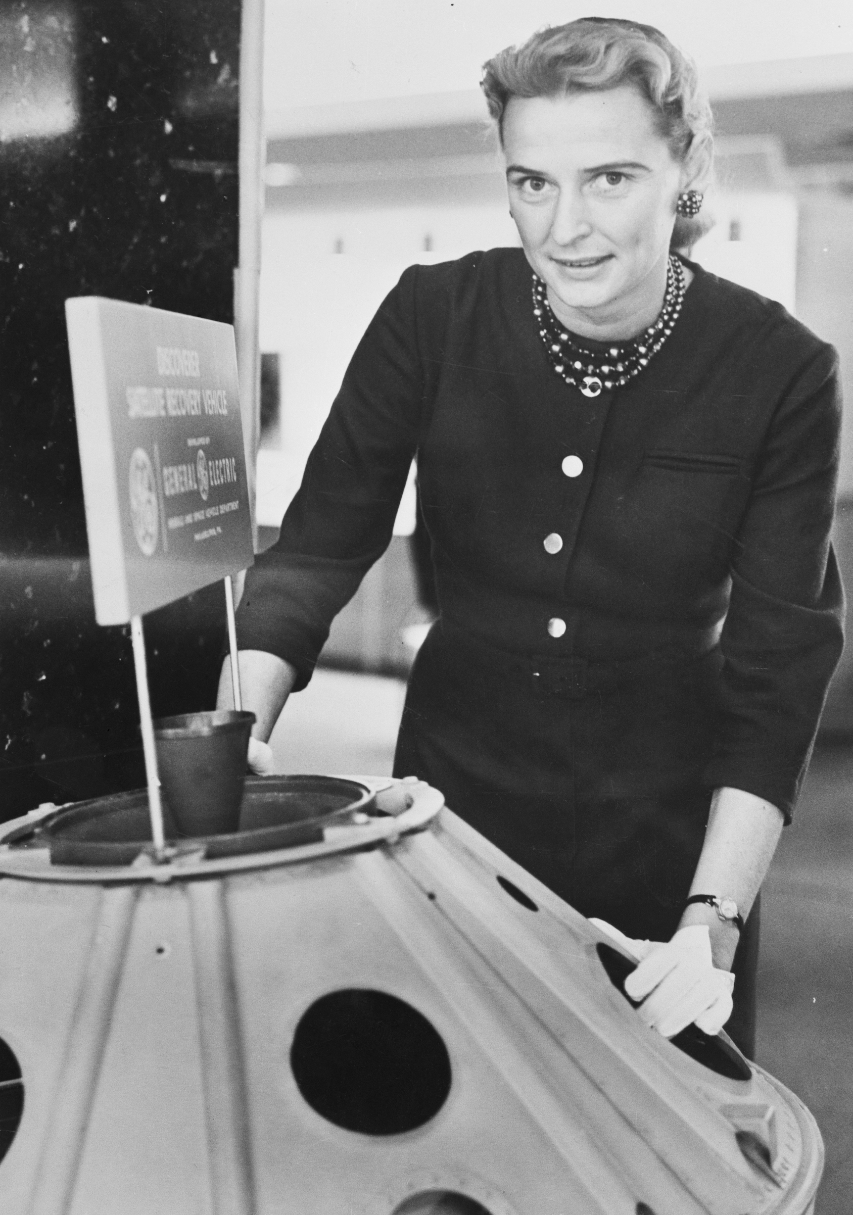 Jerrie Cobb Standing Near Satellite Model