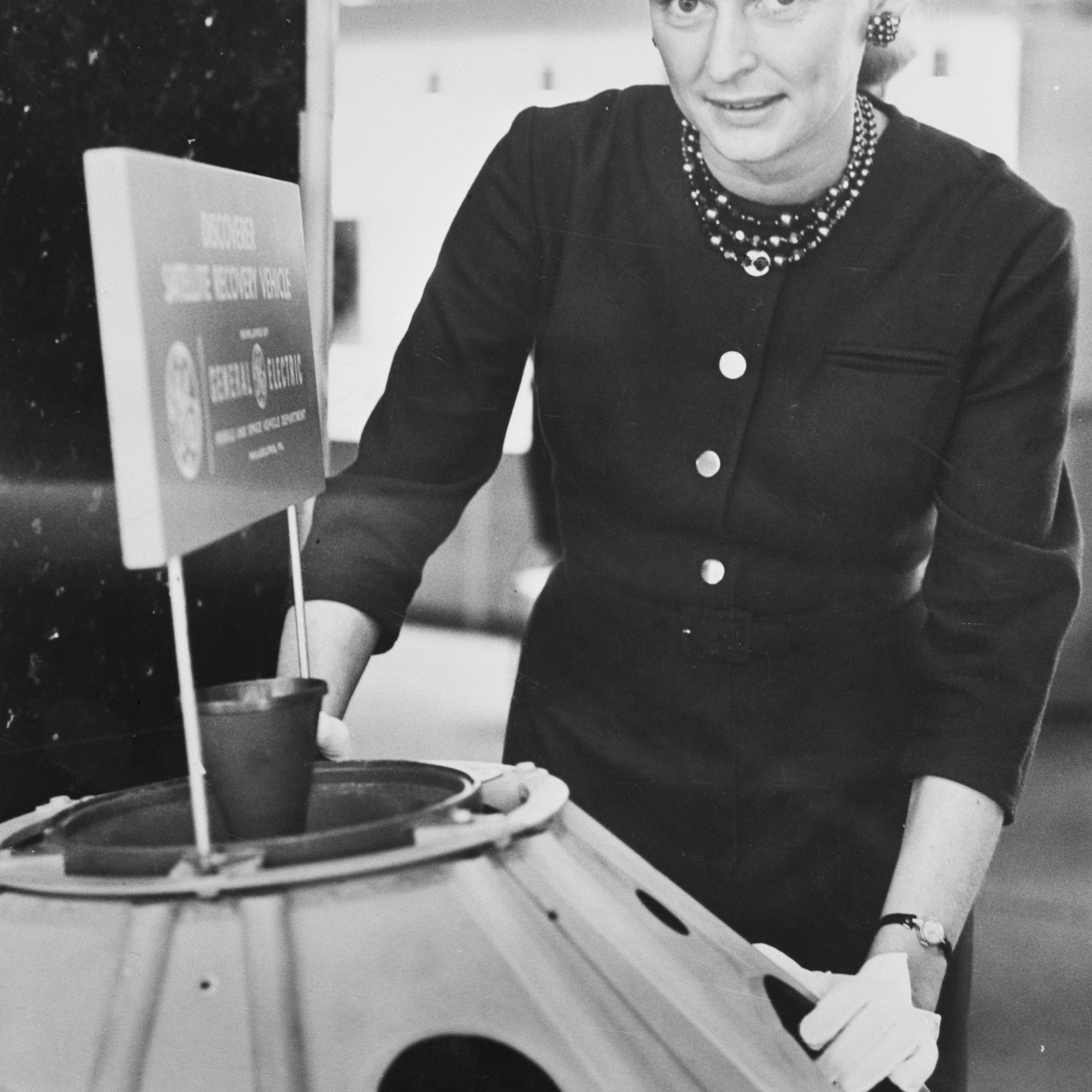 Jerrie Cobb Standing Near Satellite Model