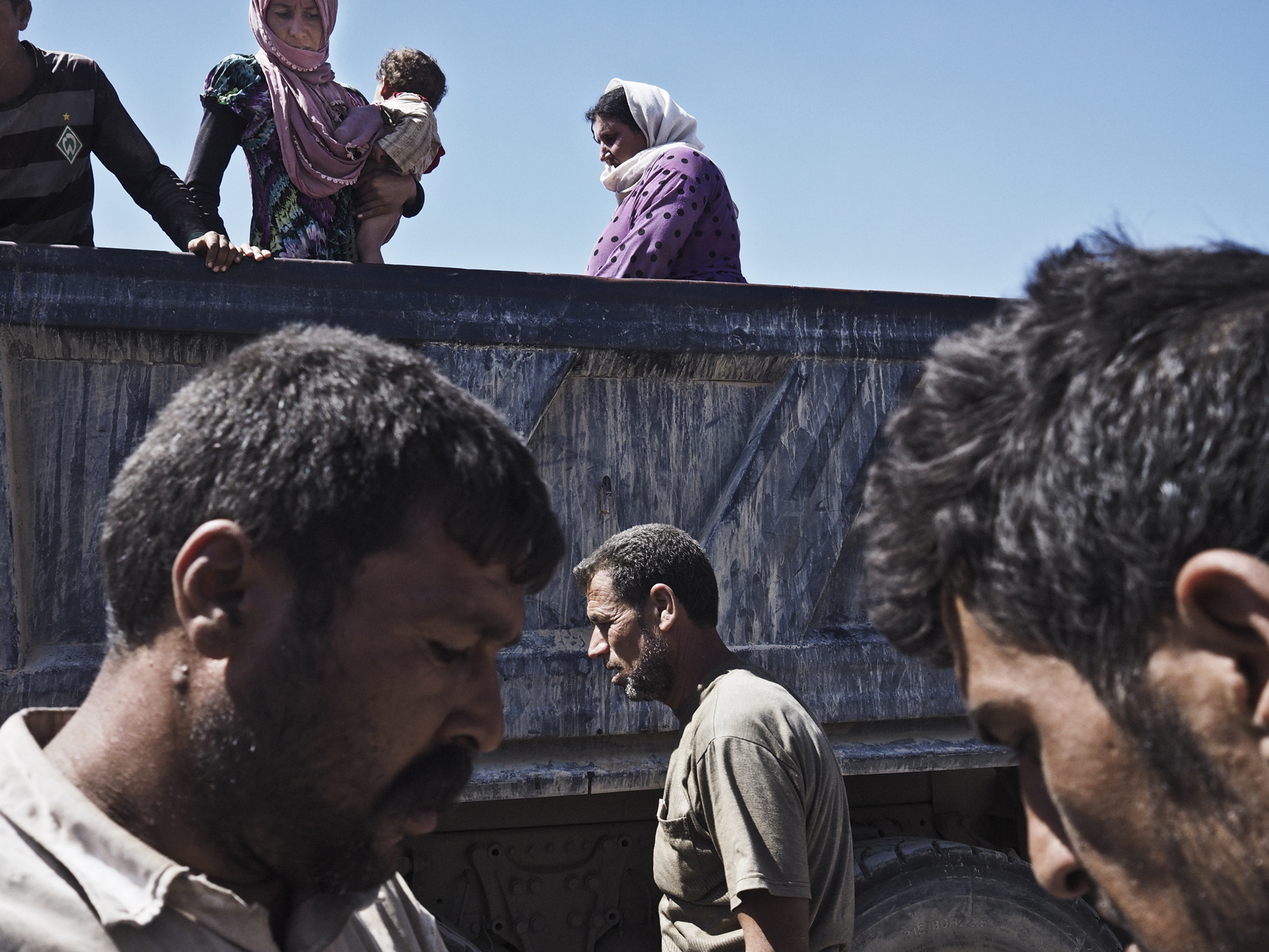 Fishkhabur, Dohuk Province, Iraq. August 10, 2014.Yazidi families from Sinjar arrive at the Fishkhabur border crossing between Iraq's Dohuk Province and Syria. Thousands of Yazidi families have fled their villages in the Sinjar region of northern Iraq an