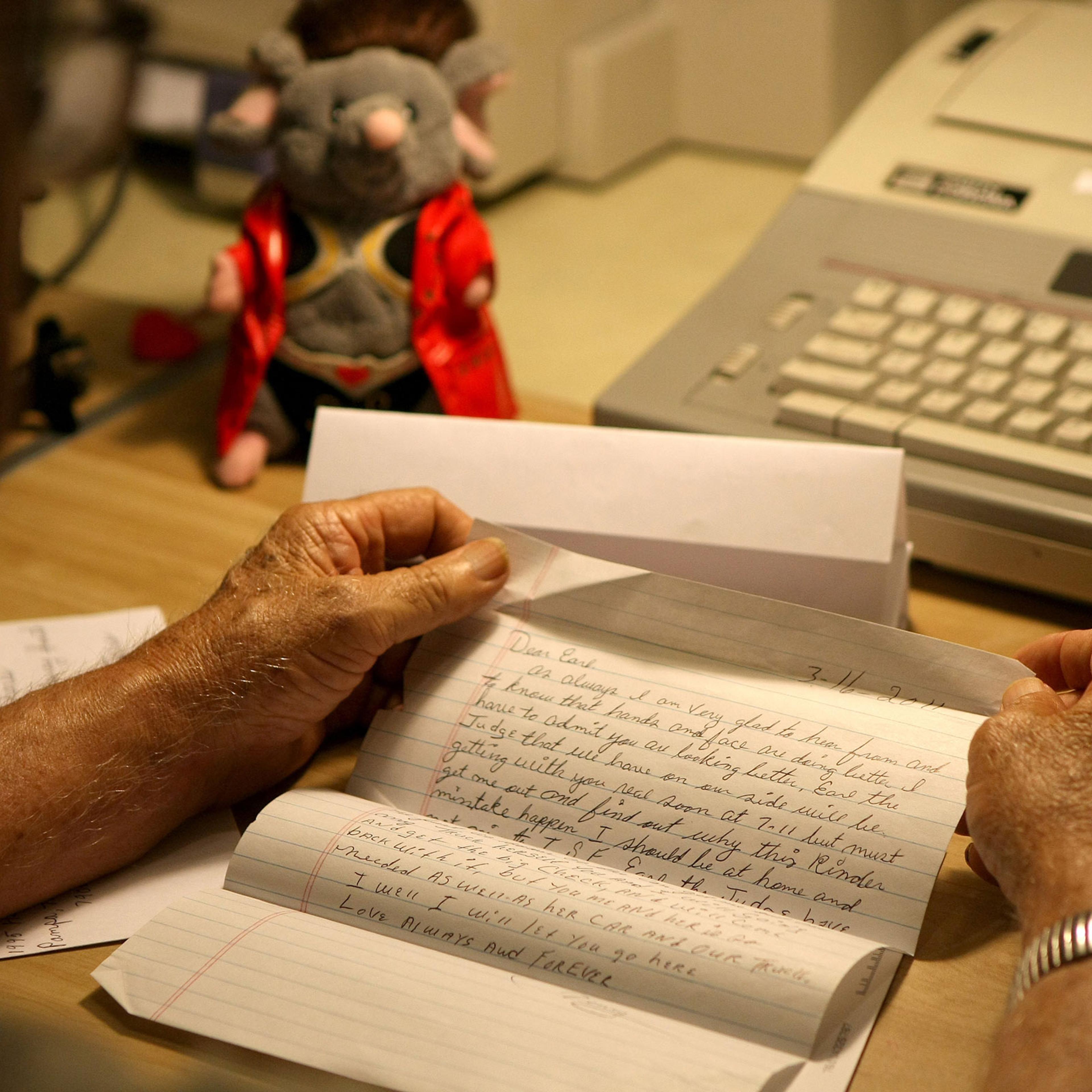 a letter written to an inmate in prison, held in a man’s hands