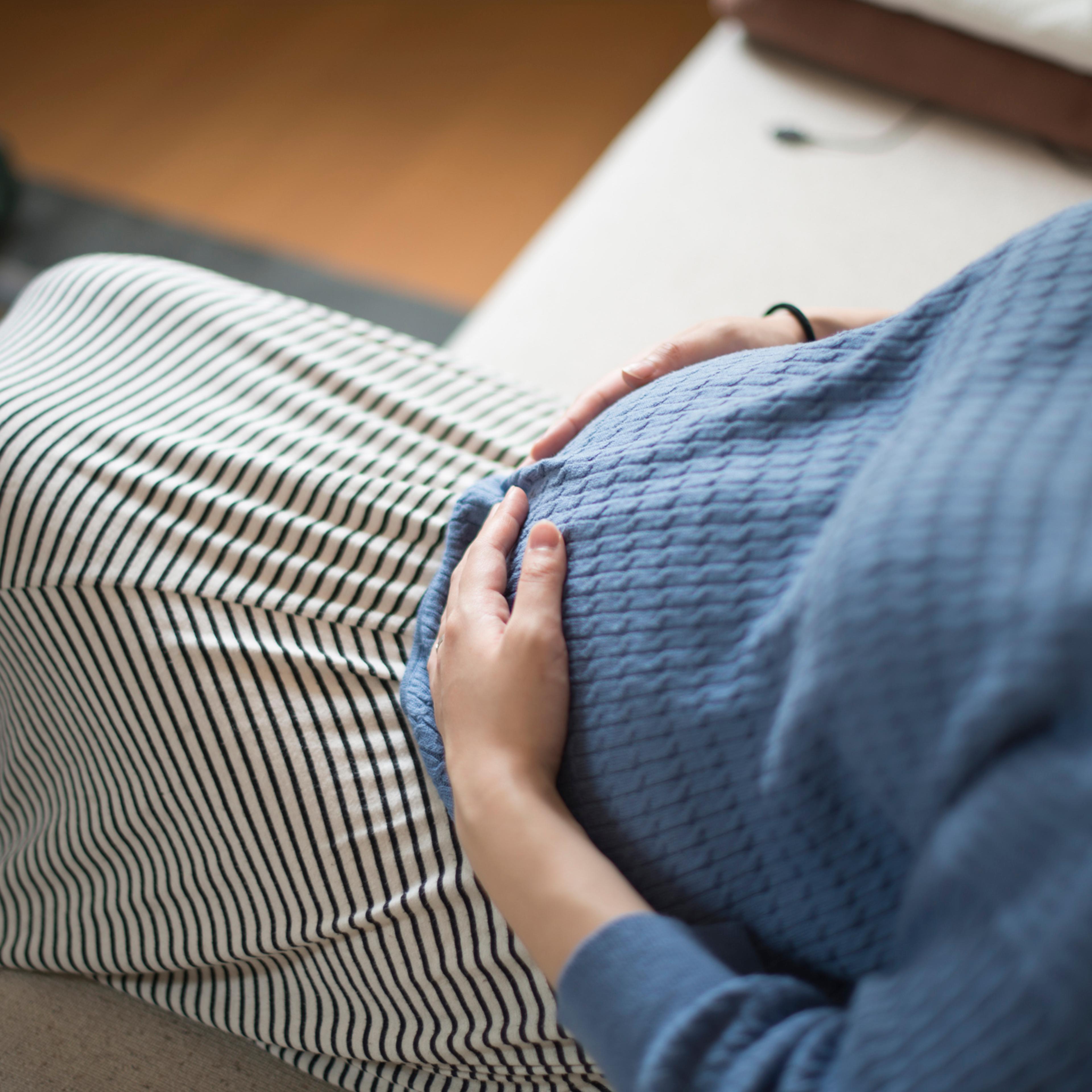 A woman in 9th months of pregnancy at living room.