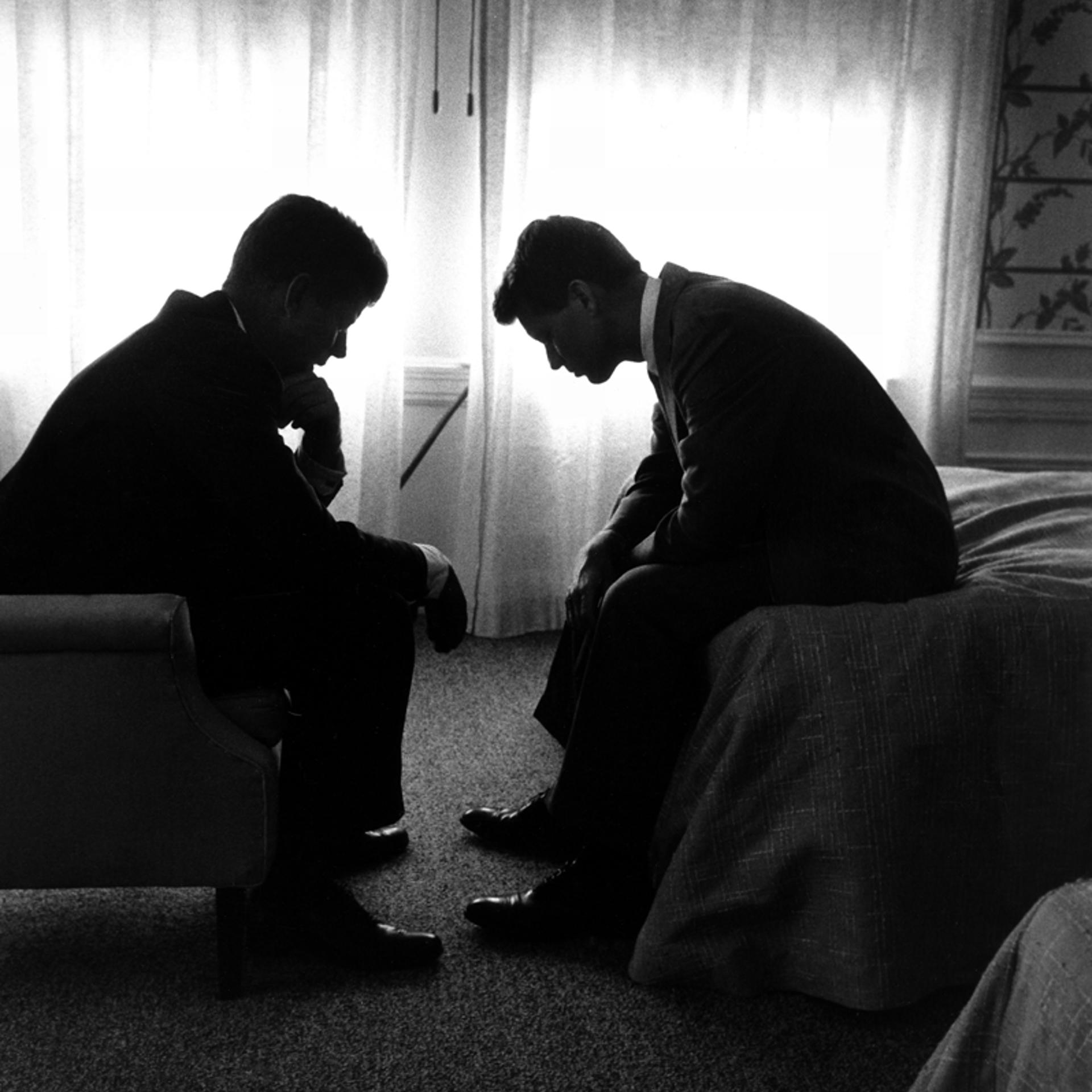 Senator and presidential candidate John F. Kennedy (left) and his campaign manager, Robert Kennedy, confer in a hotel room during the Democratic National Convention, Los Angeles, July 1960.