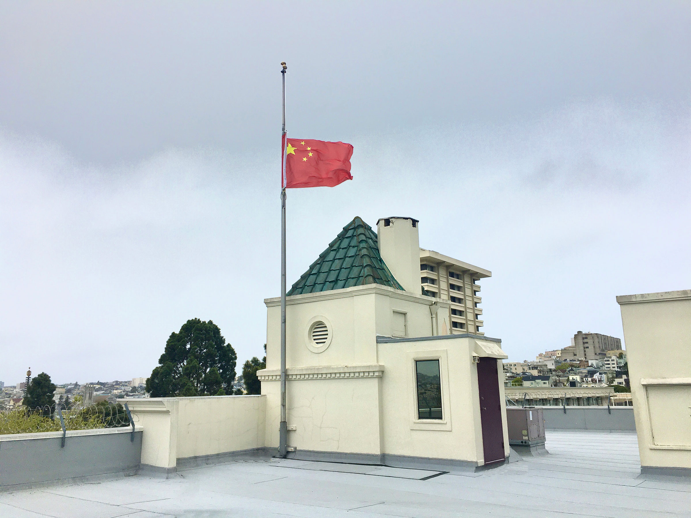 A Chinese national flag flies at half-mast to mourn for martyrs who died in the fight against COVID-19 at the Consulate-General of the People's Republic of China in San Francisco
