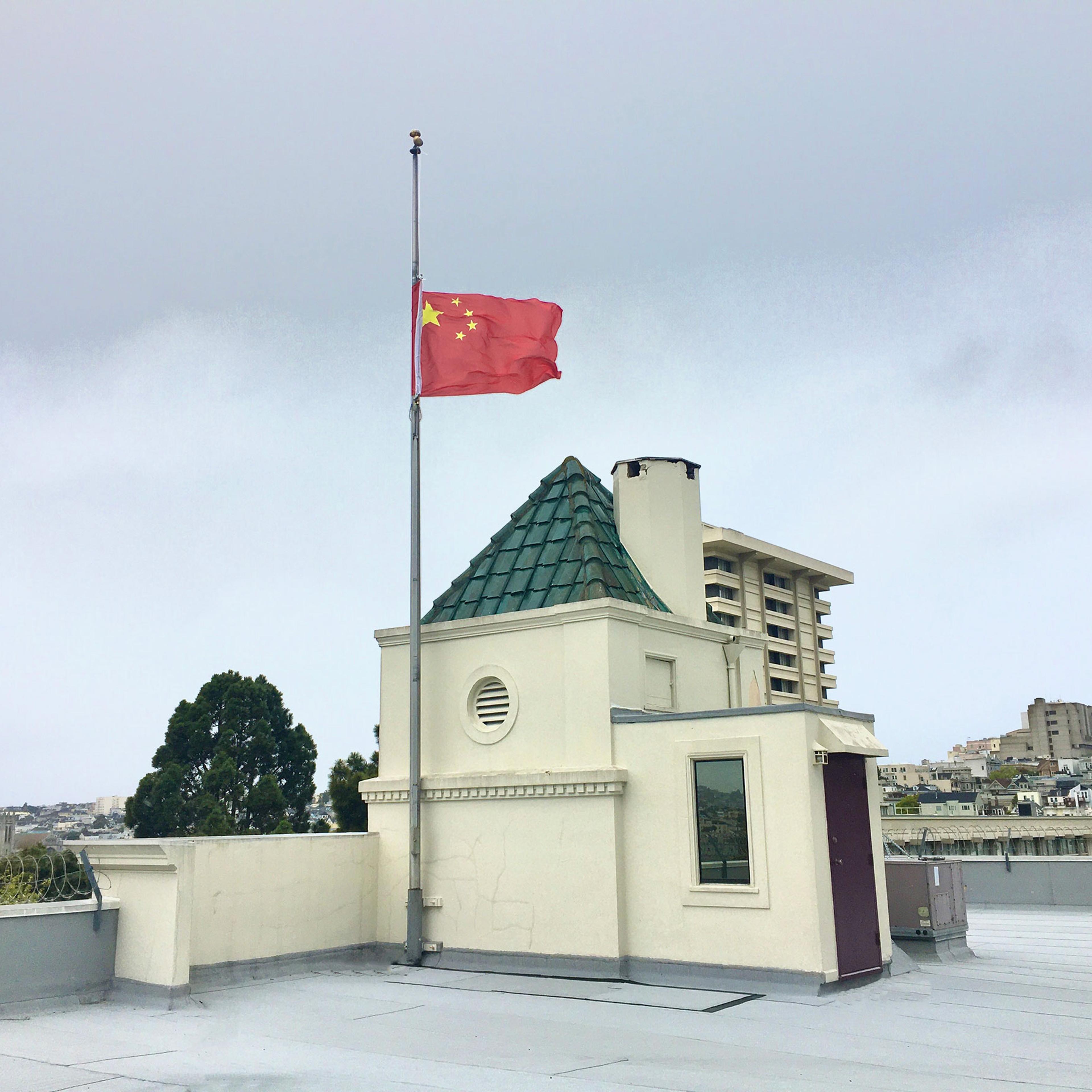 A Chinese national flag flies at half-mast to mourn for martyrs who died in the fight against COVID-19 at the Consulate-General of the People's Republic of China in San Francisco