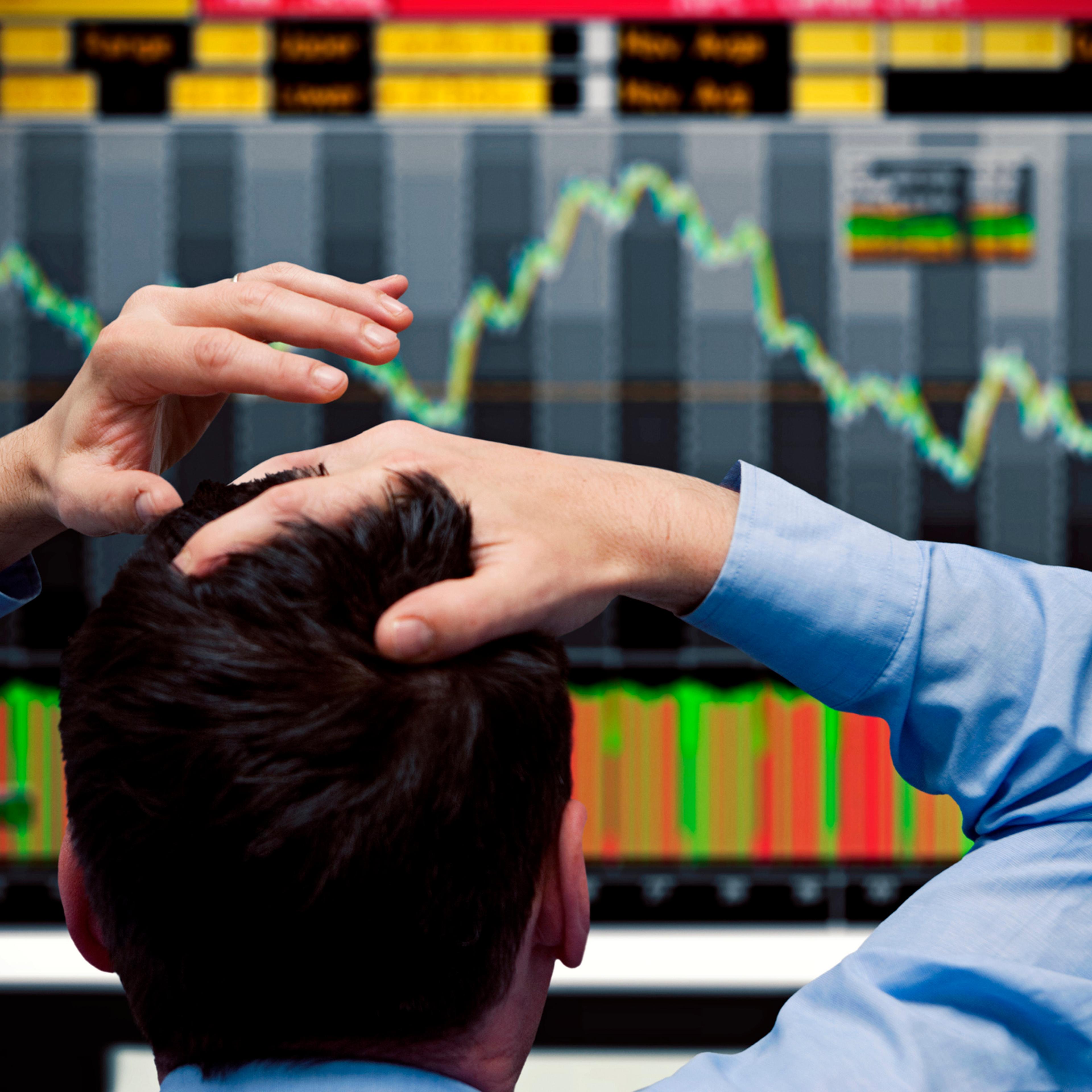 Trader watching stocks crash on screen