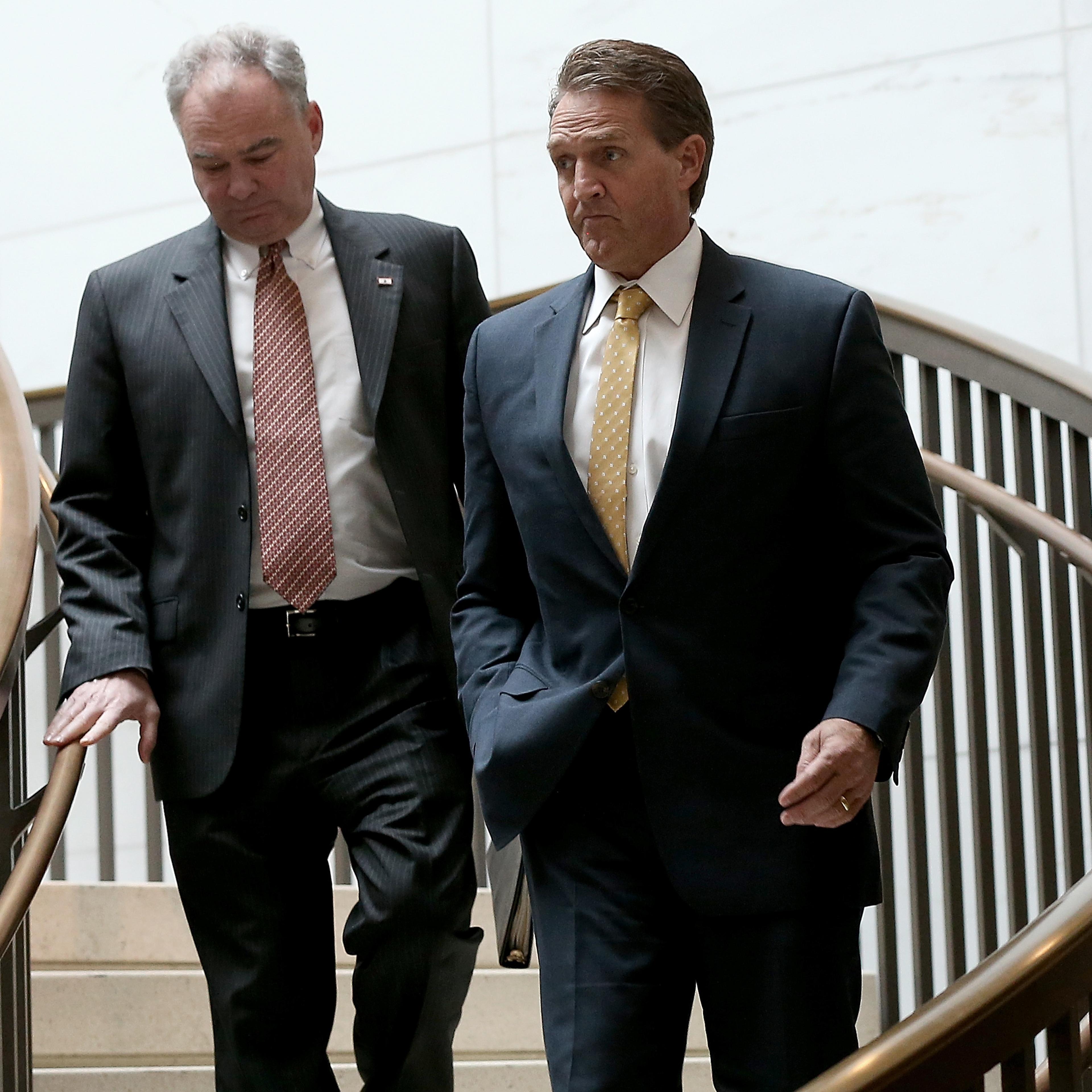 Sen. Jeff Flake (R) (R-AZ) and Sen. Tim Kaine (L) (D-VA) walk to a closed briefing at the U.S. Capitol on Nov. 10, 2015.