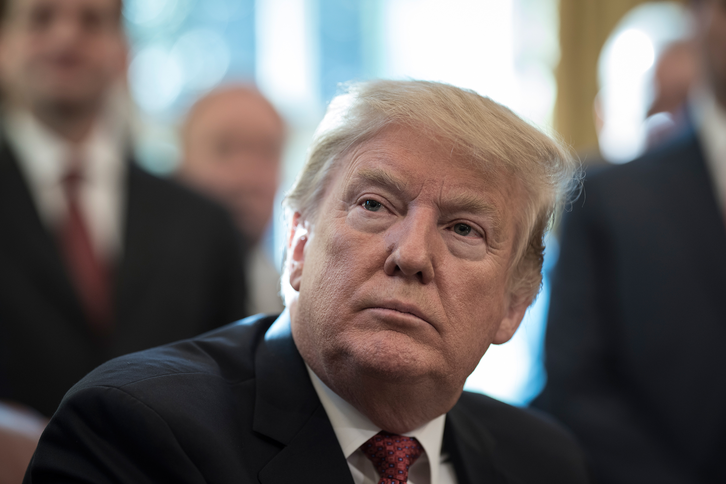 President Donald Trump speaks with reporters in the White House.