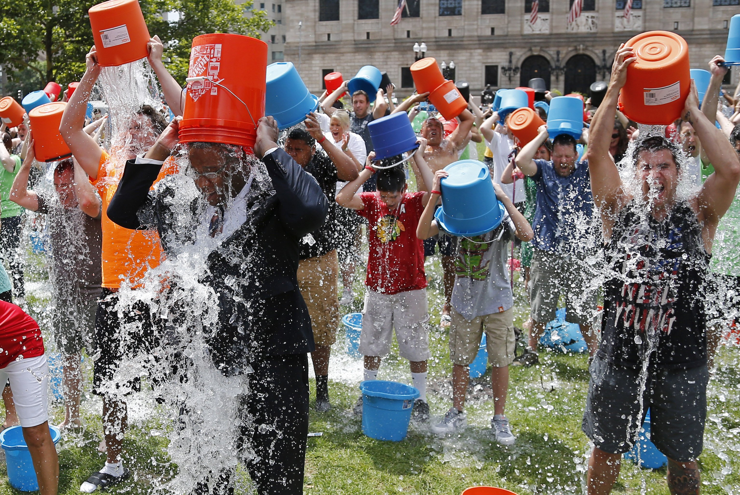 Boston City Councillor Tito Jackson, leads some 200 people in the ice bucket challenge at Boston's Copley Square, Aug. 7, 2014 to raise funds and awareness for ALS.