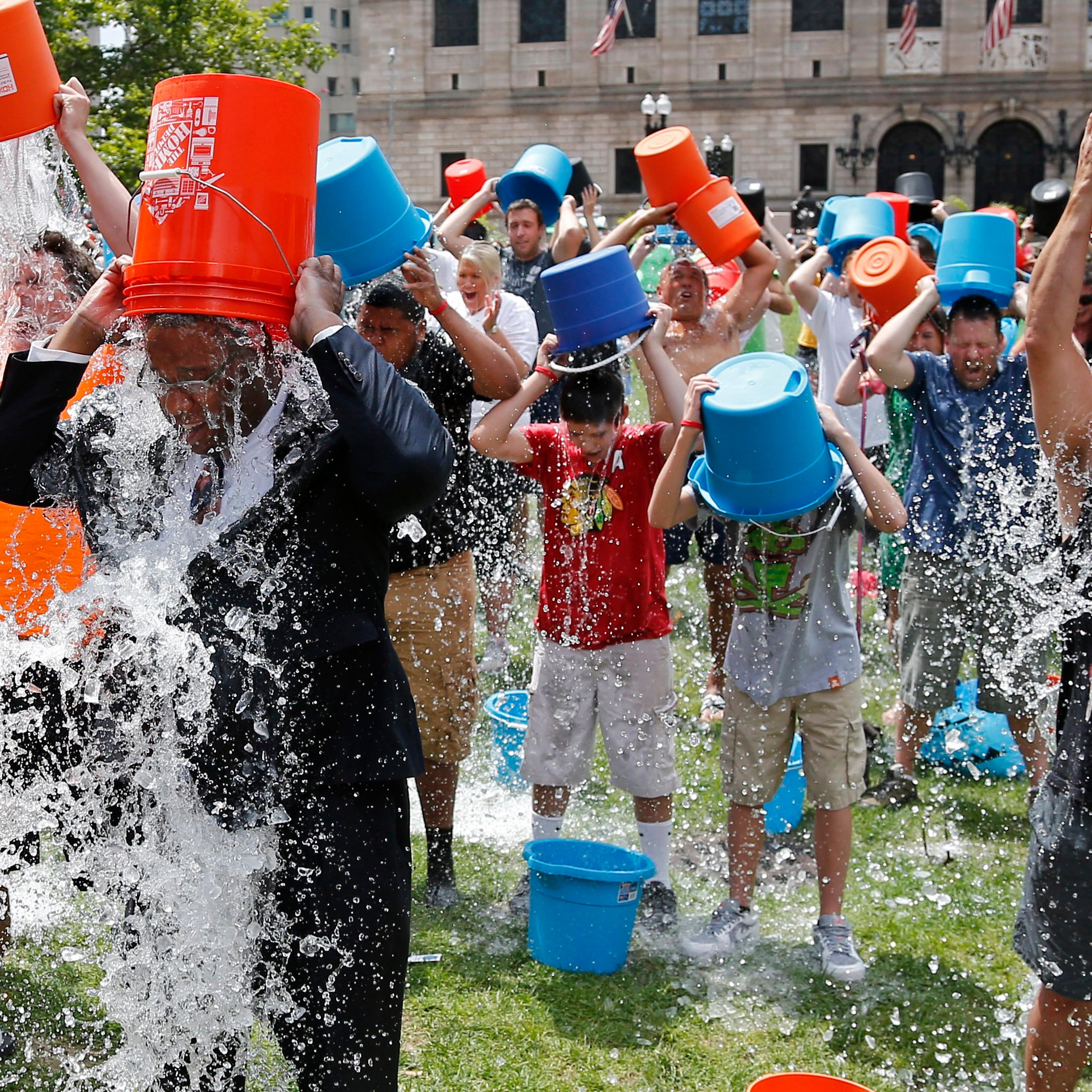 Boston City Councillor Tito Jackson, leads some 200 people in the ice bucket challenge at Boston's Copley Square, Aug. 7, 2014 to raise funds and awareness for ALS.