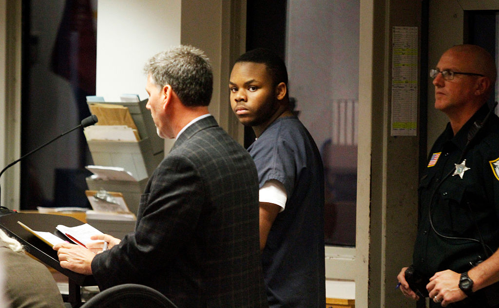 Malachi Love-Robinson, then-18, of West Palm Beach, looks over at his grandfather during his first appearance court hearing on March 2, 2016 at the Palm Beach County Court Criminal Justice Complex in West Palm Beach, Fla.