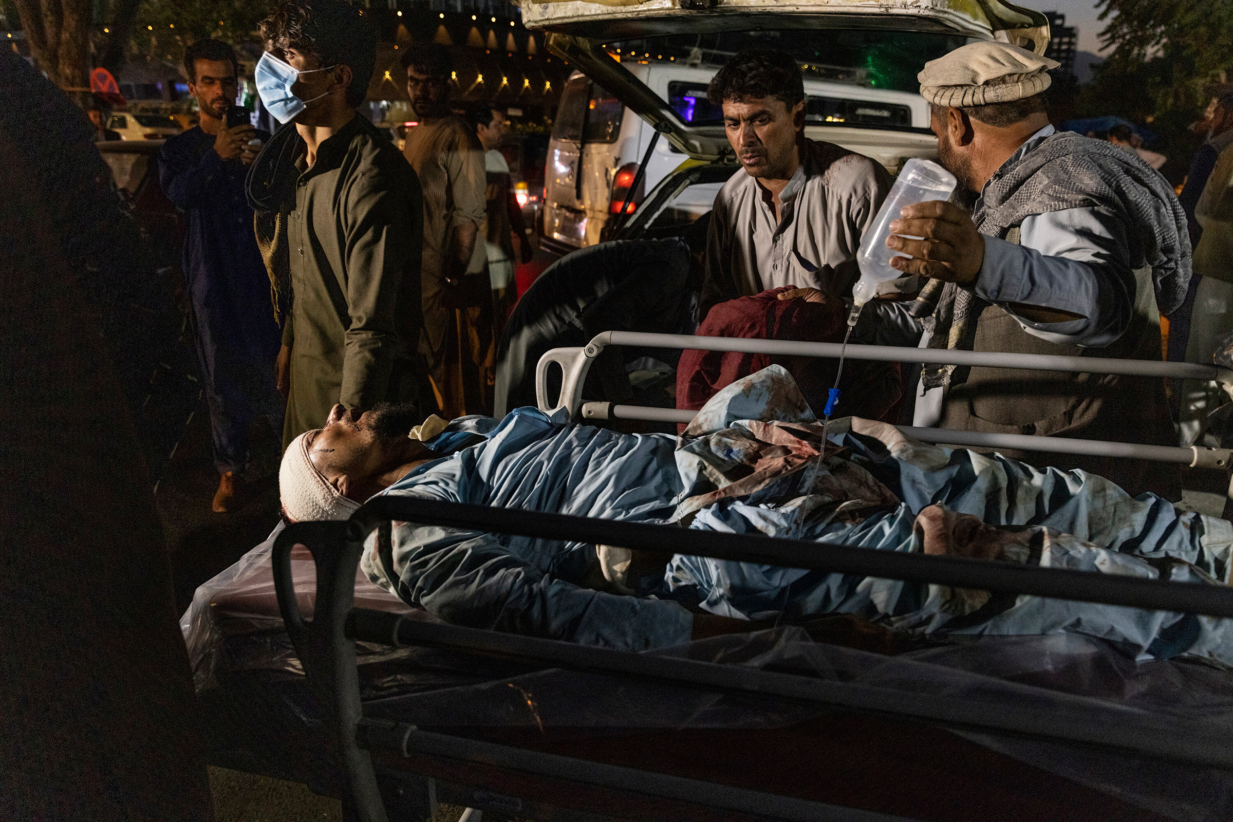 A wounded person is transported outside the international airport in Kabul on Aug. 26.