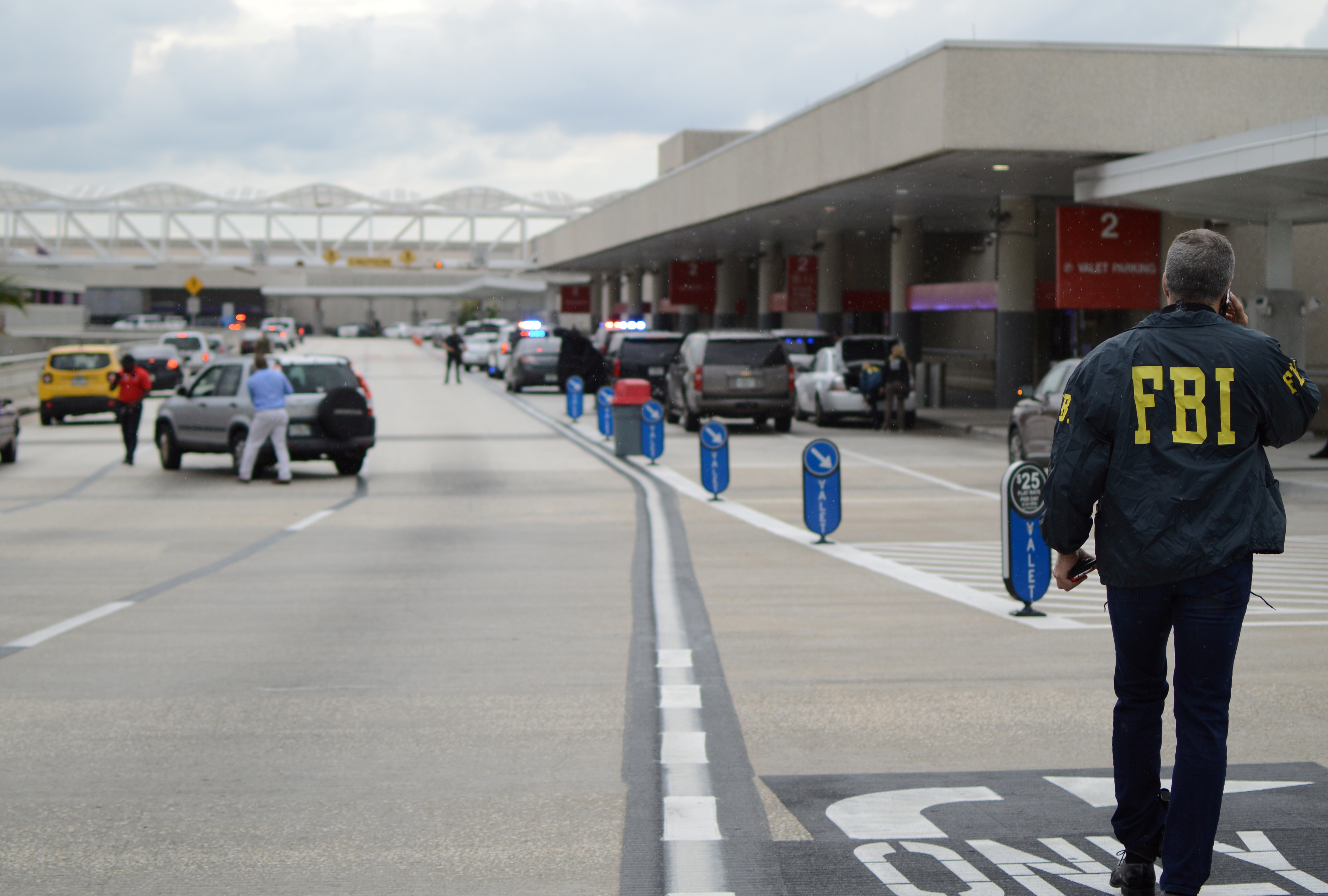 Law enforcement walk outside a terminal after a shooter opened fire at a baggage carousel at Fort Lauderdale-Hollywood International Airport in Fort Lauderdale, Fl., Jan. 6, 2017.
