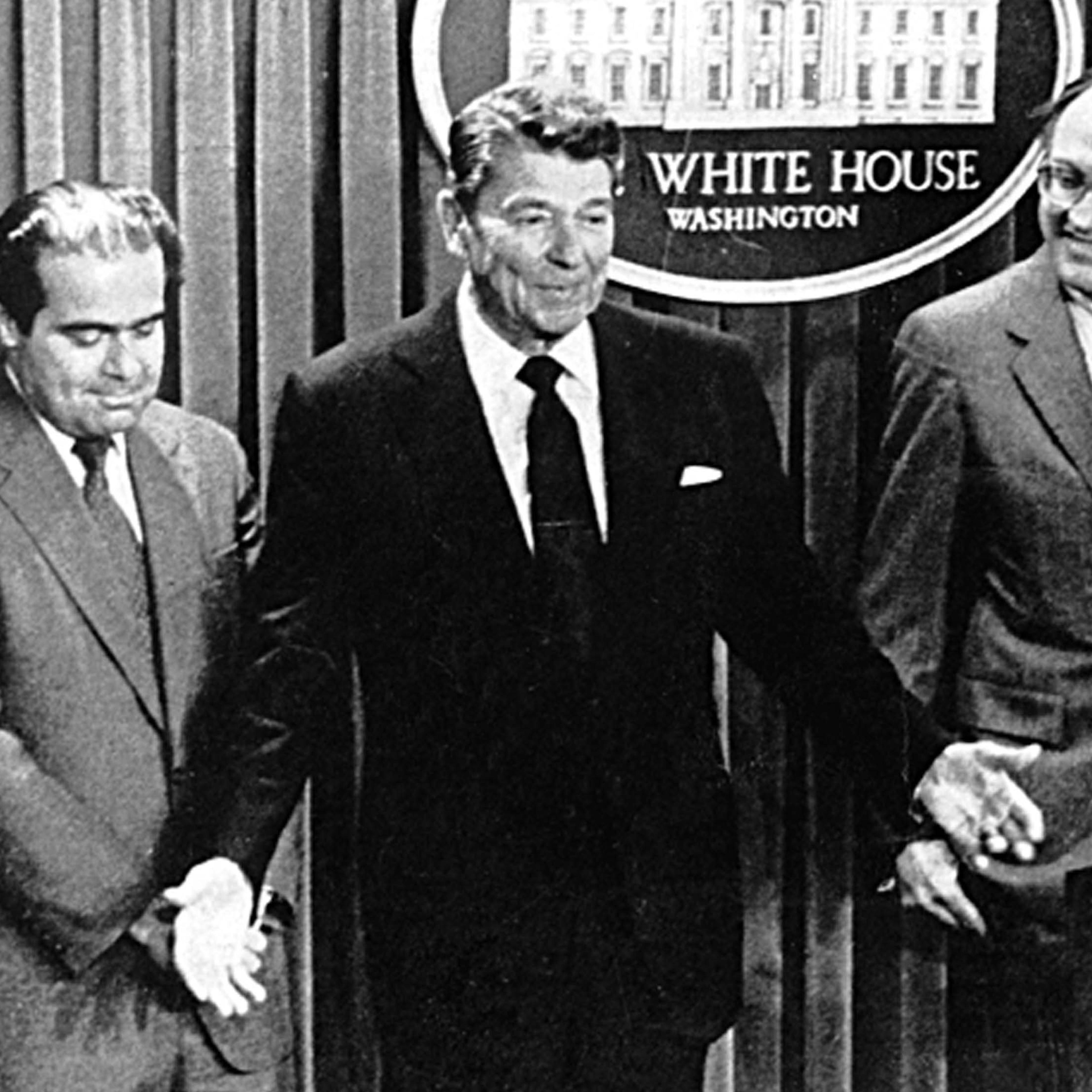 In this 1986 photo shows President Ronald Reagan with Antonin Scalia, left, whom he appointed to fill the Supreme Court post of William H. Rehnquist, right, who was elevated to the position of chief justice, in 1986.