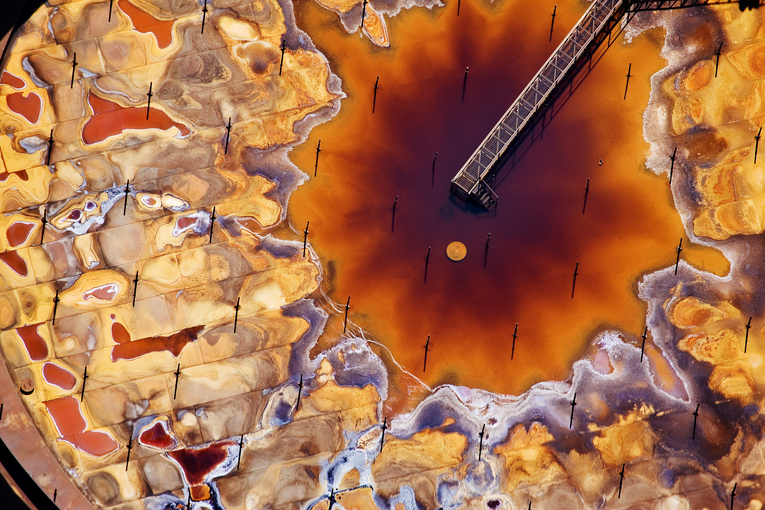 Fort McMurray, Canada The first step in the oil sands process after extraction is ‘upgrading’, in which particulate matter is removed from the bitumen and its viscosity reduced so that refineries can process it. This is a photograph of the top of a petro